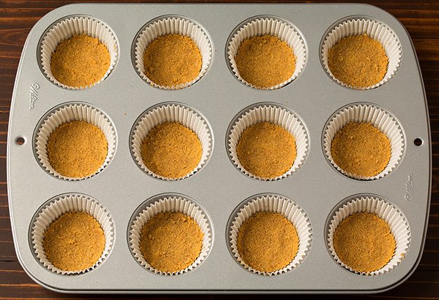 Graham cracker crusts in cupcake pan for mini pumkpin cheesecakes. 