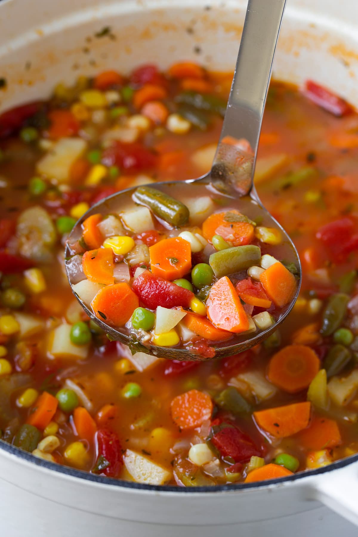 Ladle full of homemade healthy vegetable soup.