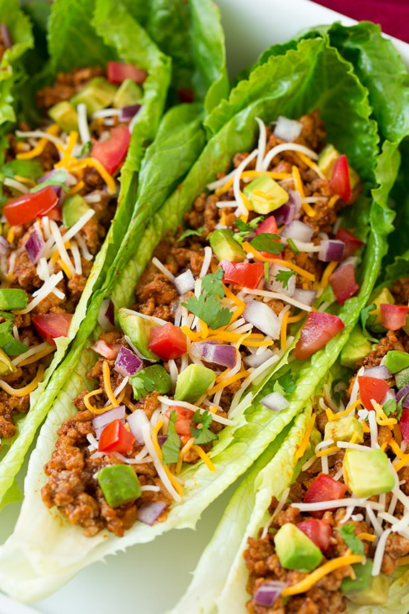 Turkey Taco Lettuce Wraps topped with avocado, tomatoes and cheese