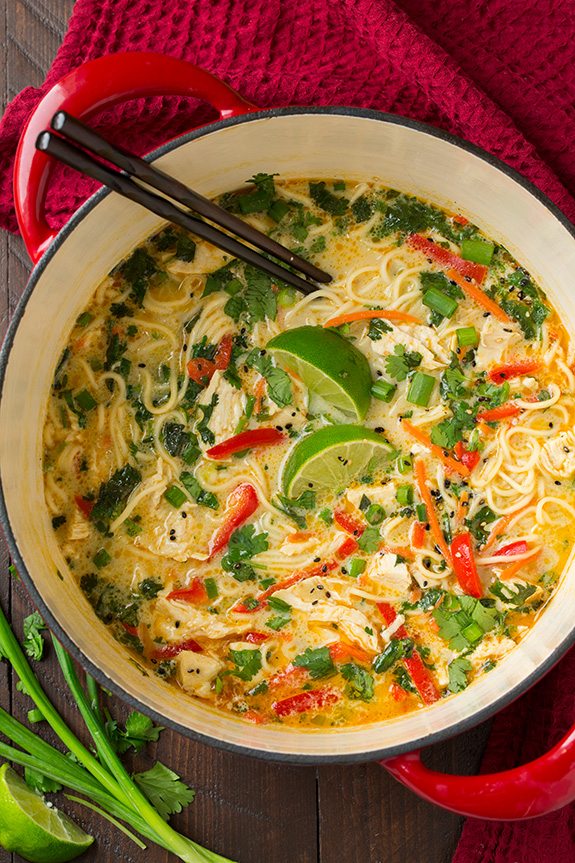 large pot of Thai Chicken Ramen garnished with lime wedges