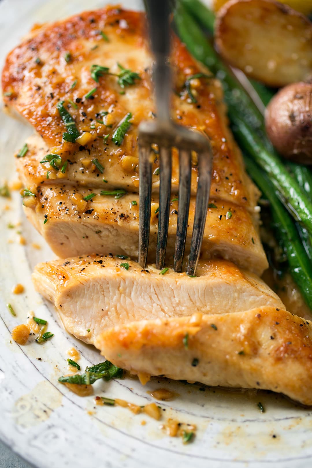 Skillet Chicken cut into slices with a fork picking up a piece