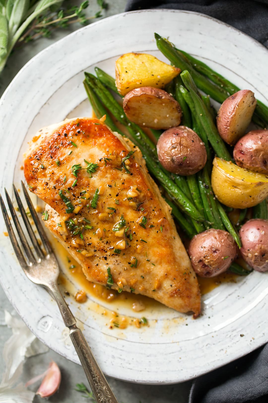 Skillet Chicken with Garlic Herb Butter Sauce on a plate with veggies