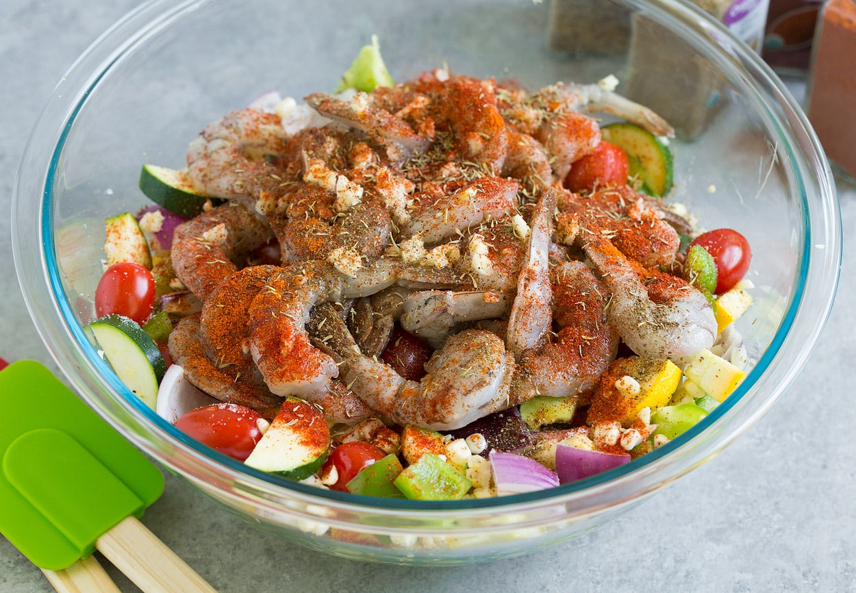 Shrimp Foil Packs tossing all ingredients together in mixing bowl