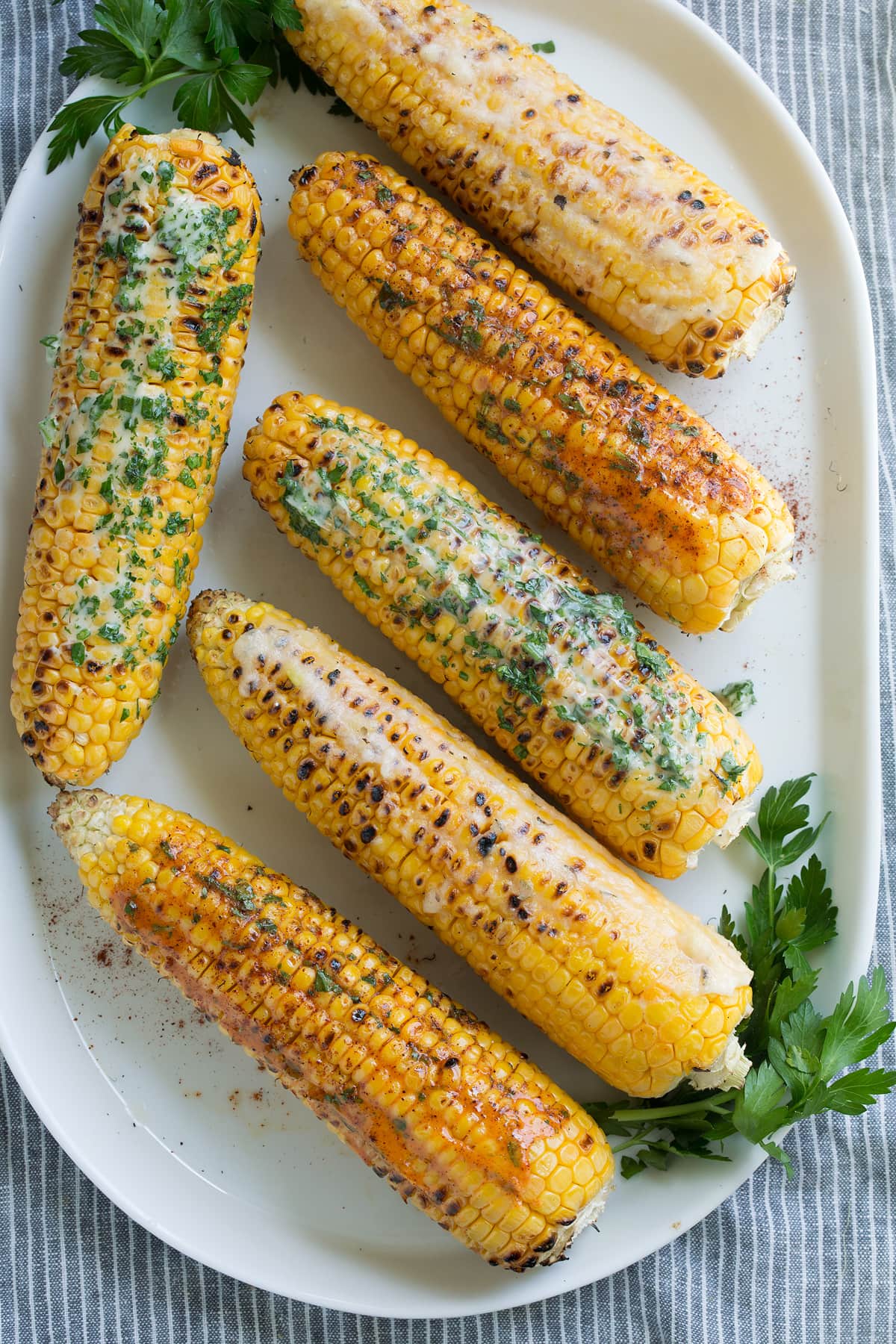 Grilled Corn on the Cob + 3 Flavored Butters Six grilled corn on the cob rubbed with flavored butters.