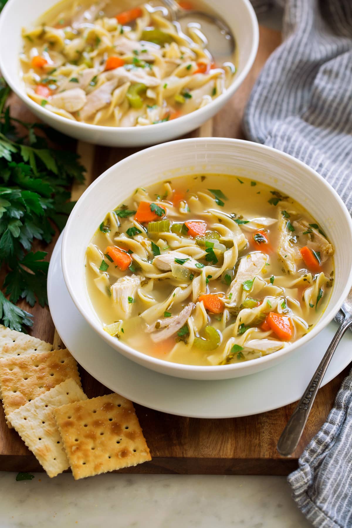 Homemade chicken noodle soup in two serving bowls.