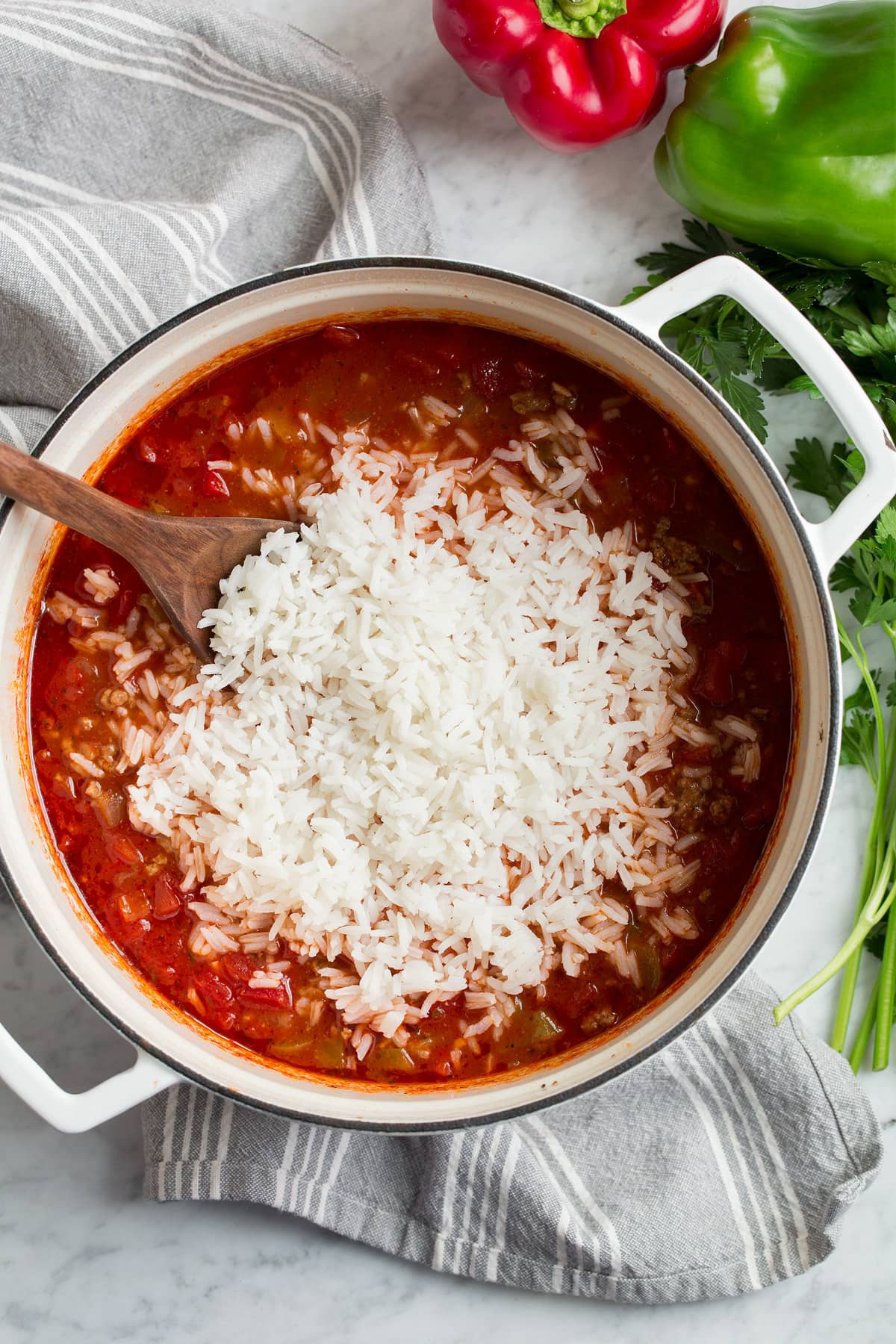 Stirring rice into stuffed pepper soup.