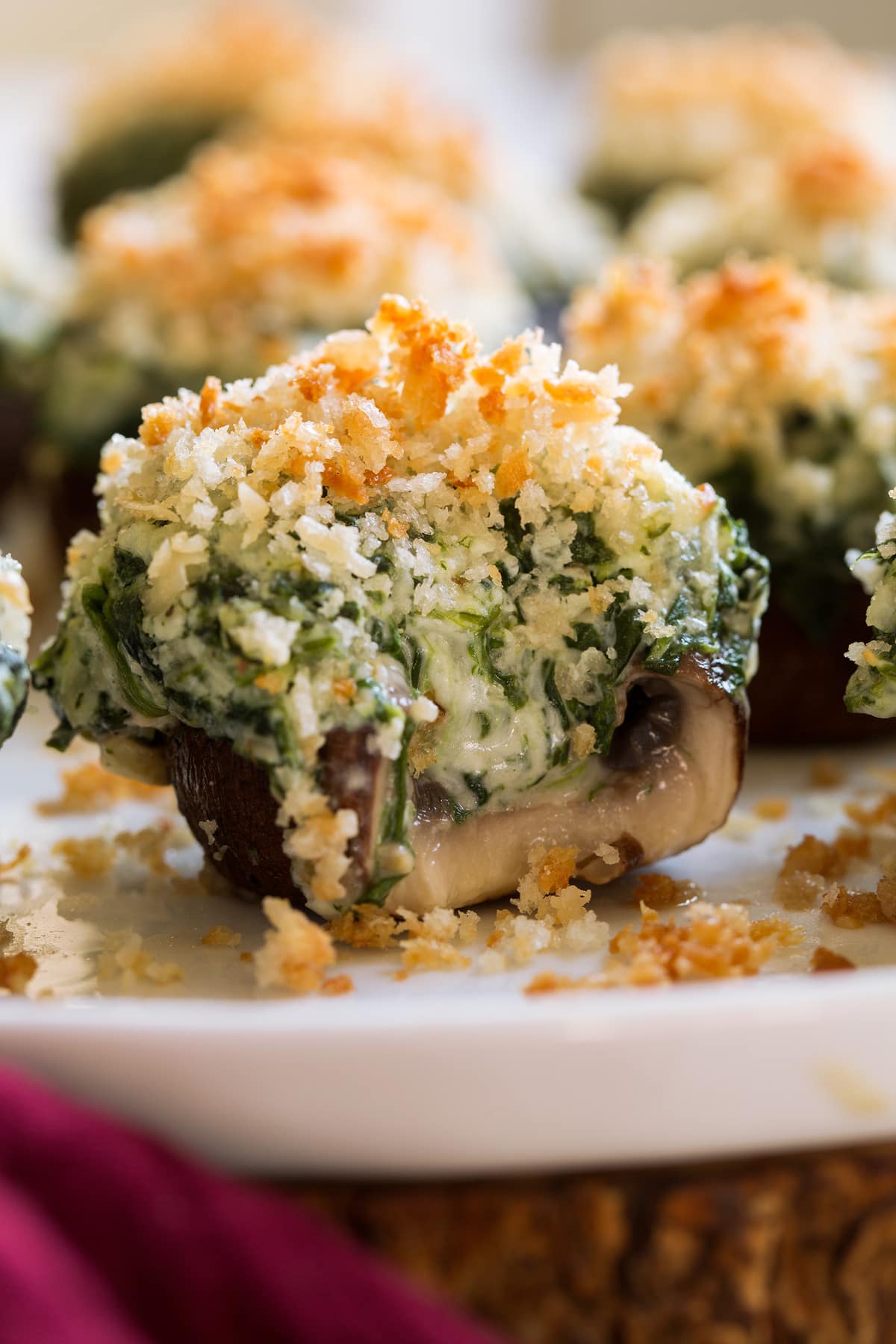 Stuffed Mushrooms Stuffed mushrooms with a bite taken out to show cheesy filling.