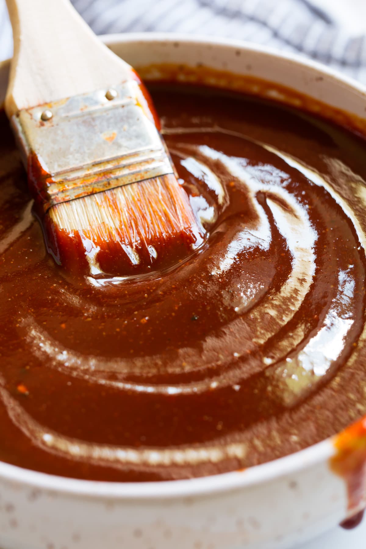 Homemade BBQ Sauce Close up image of bbq sauce with basting brush in a bowl.