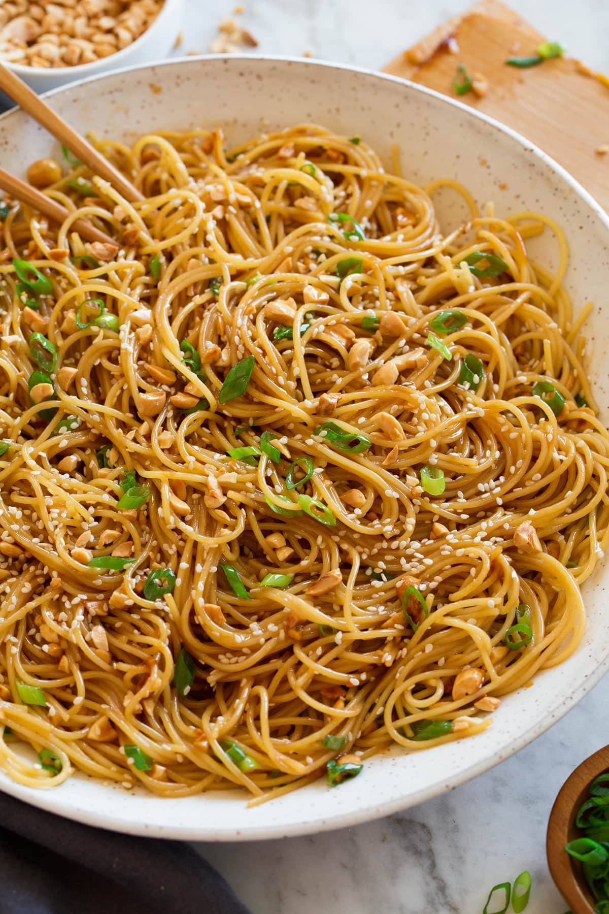 Photo: Sesame noodles shown from the side in a large white ceramic serving bowl.