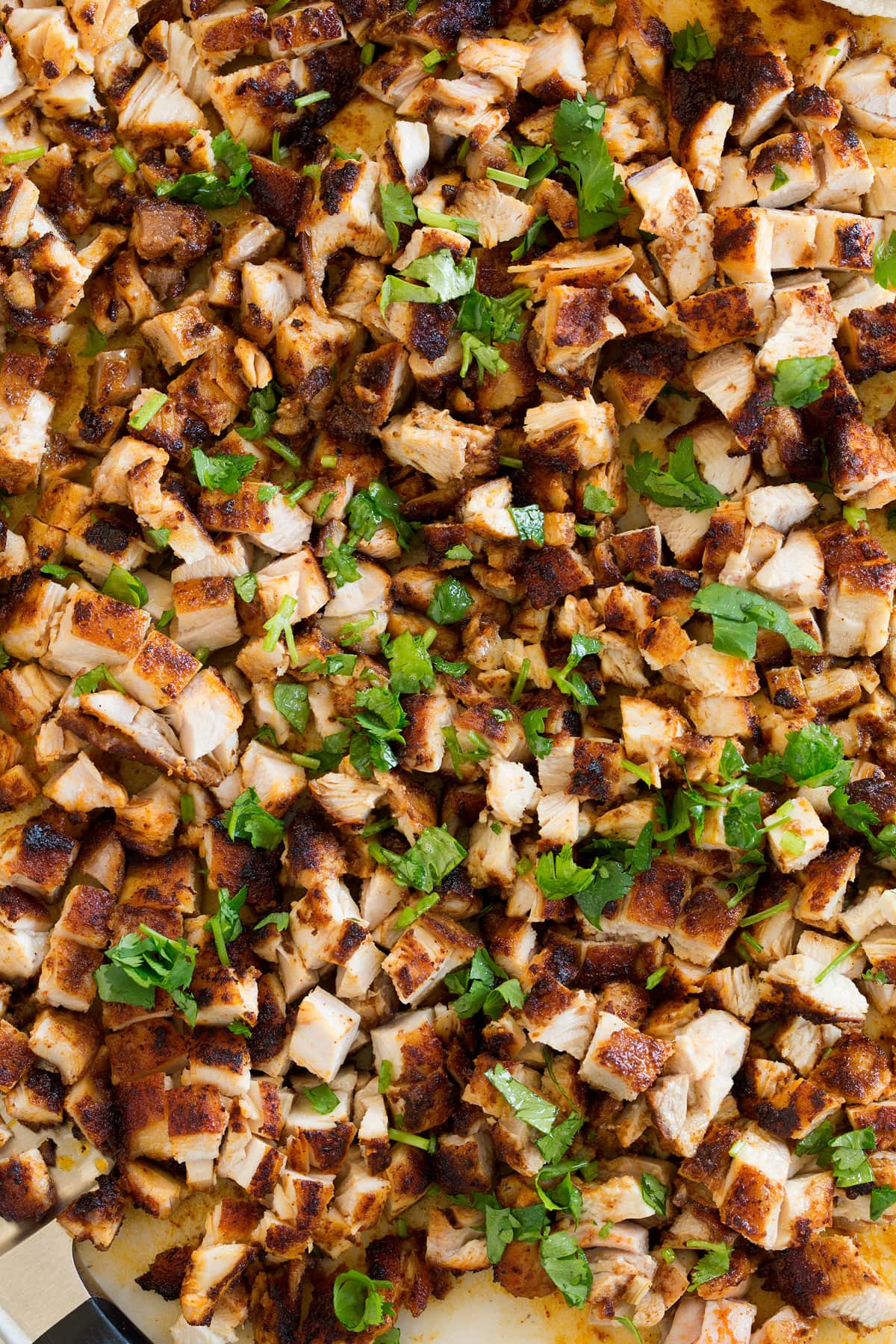 Chicken Tacos Close up overhead image of chopped, seared chicken pieces on a cutting board.