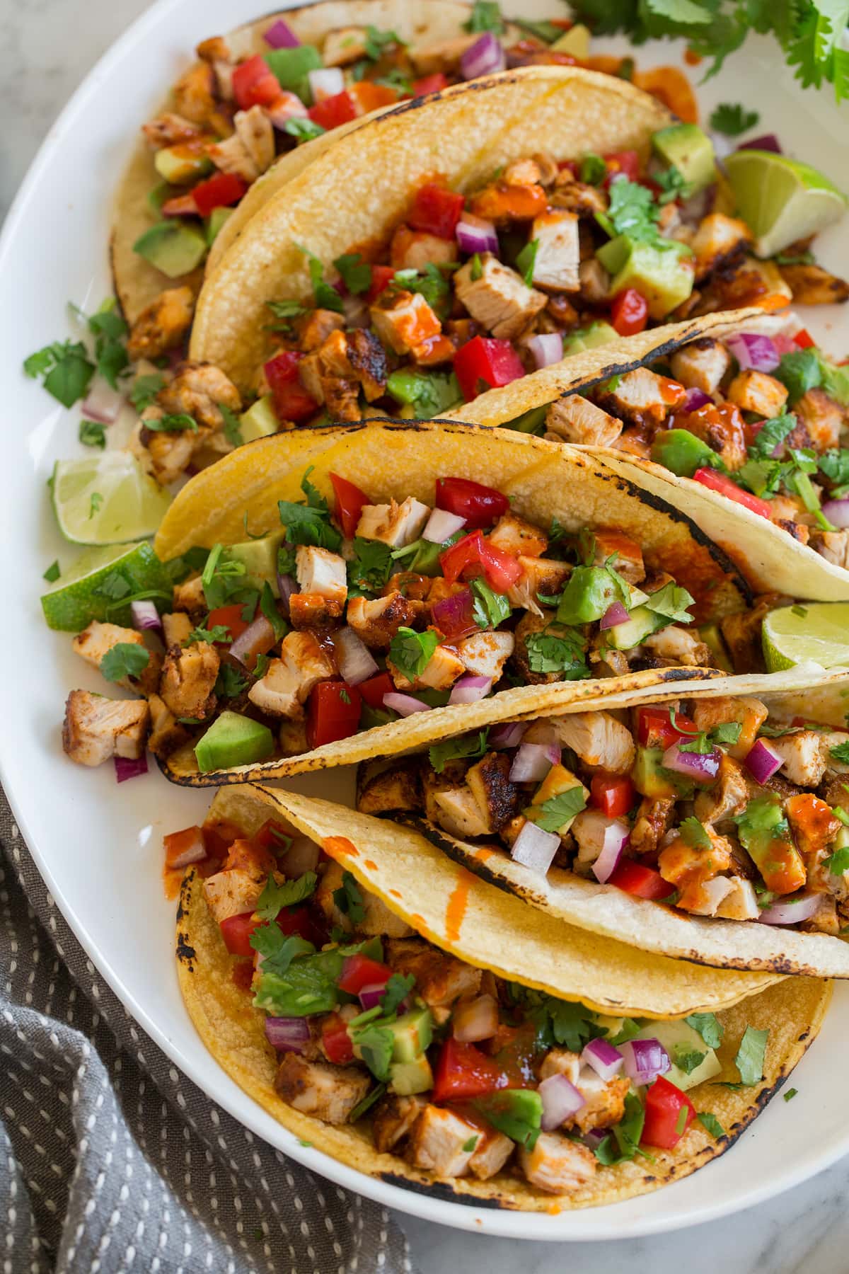 Chicken Tacos Chicken tacos on a platter shown from a side angle.
