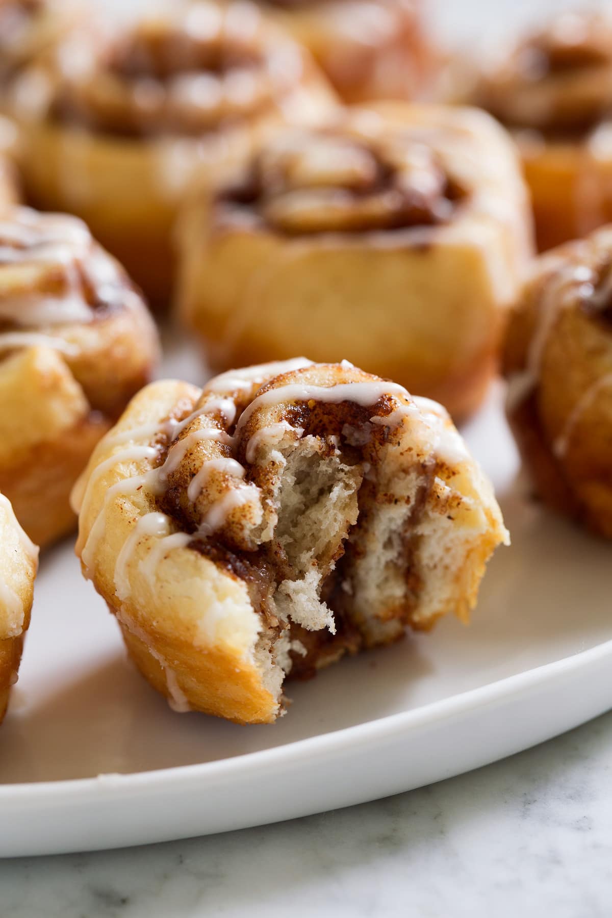 Mini Cinnamon Roll Image of mini cinnamon roll shown bitten into.