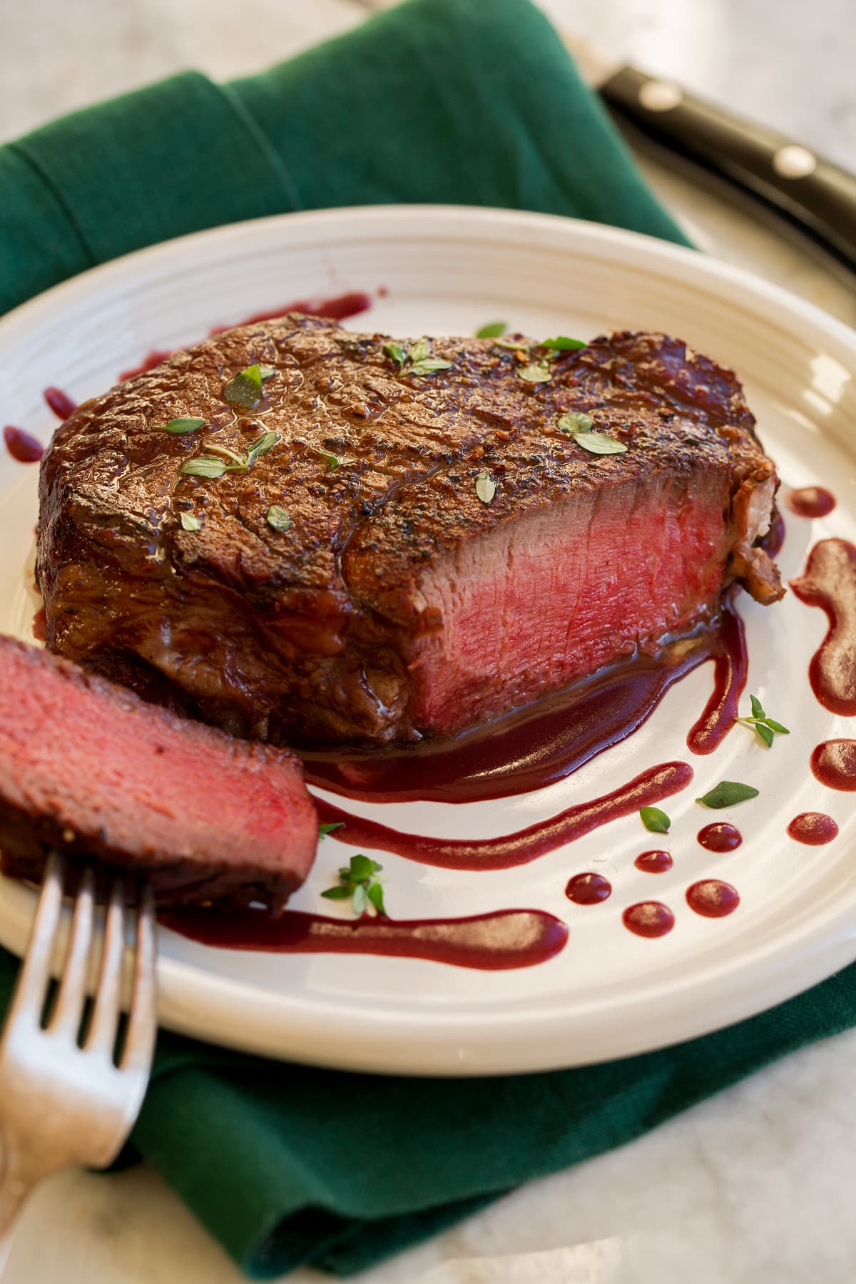 Filet Mignon Filet Mignon on a serving plate with red wine sauce.
