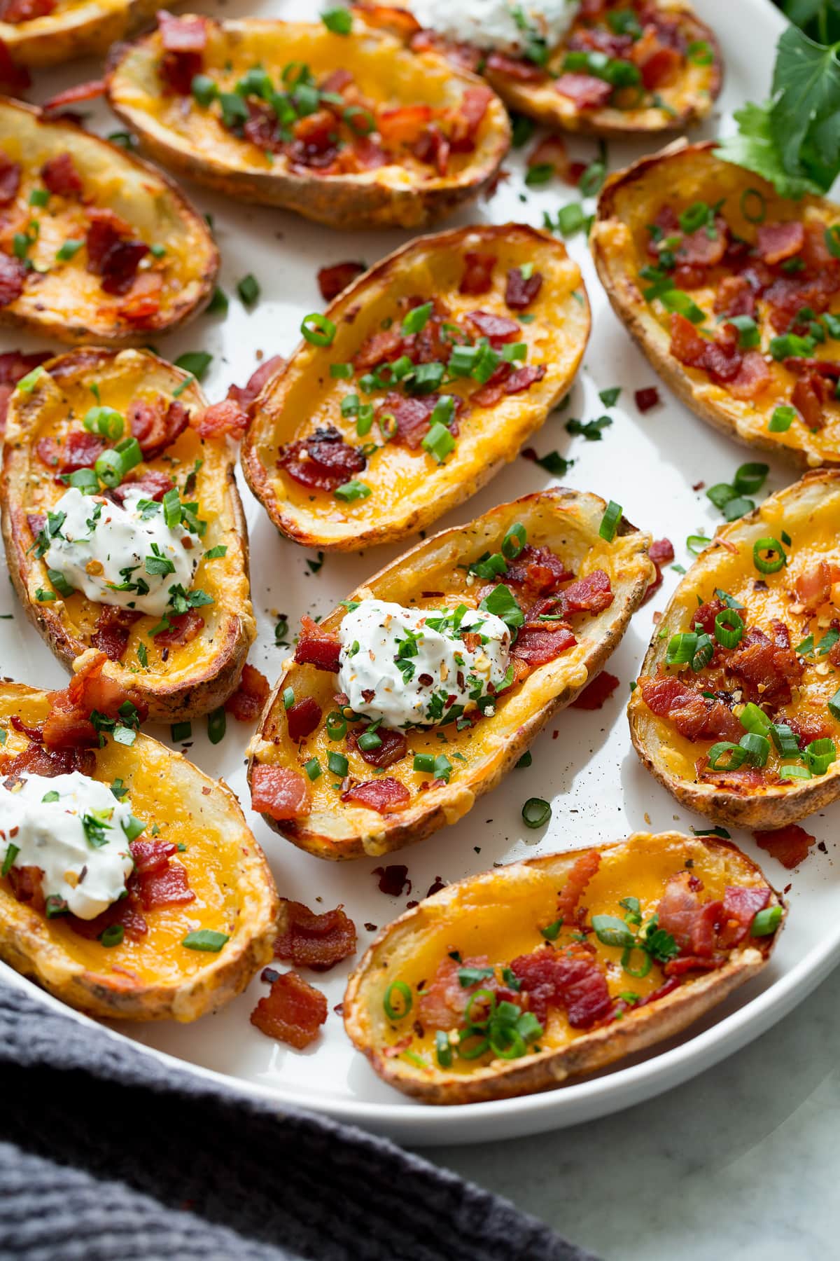 Potato Skins Potato skins shown from a side angle on a large serving platter.