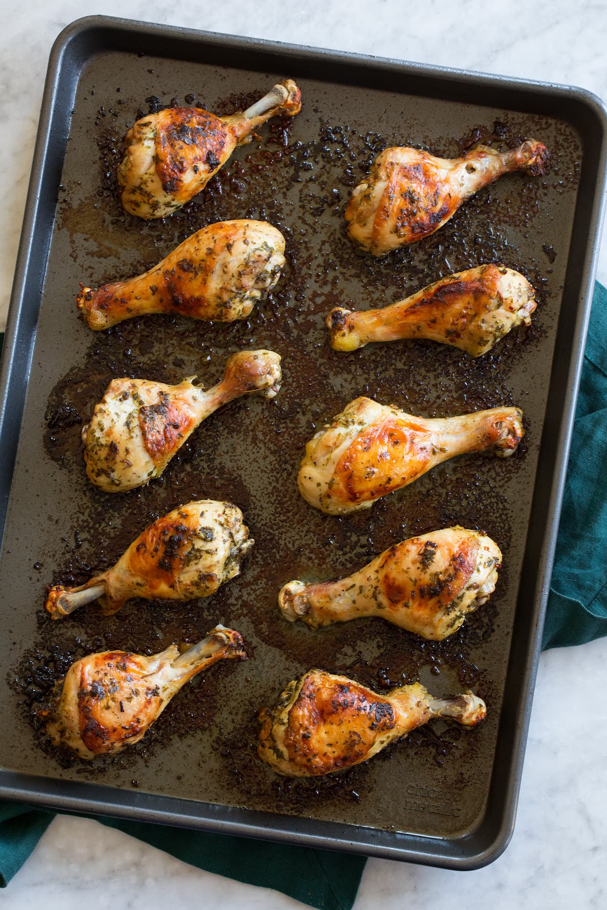 Baked Chicken Legs Chicken legs shown on a baking sheet from above, after they're done baking.