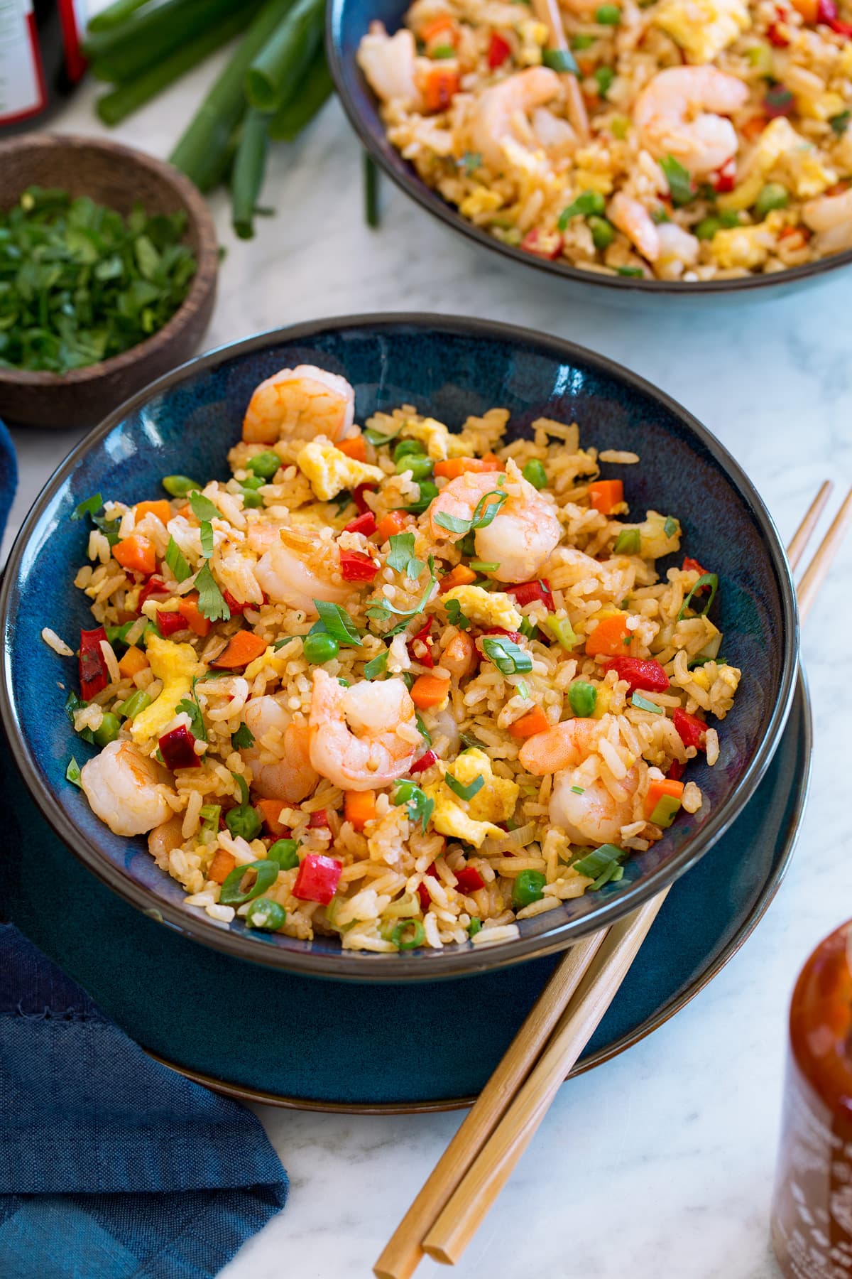 Shrimp Fried Rice Two servings of shrimp fried rice shown in blue bowls with chopsticks.