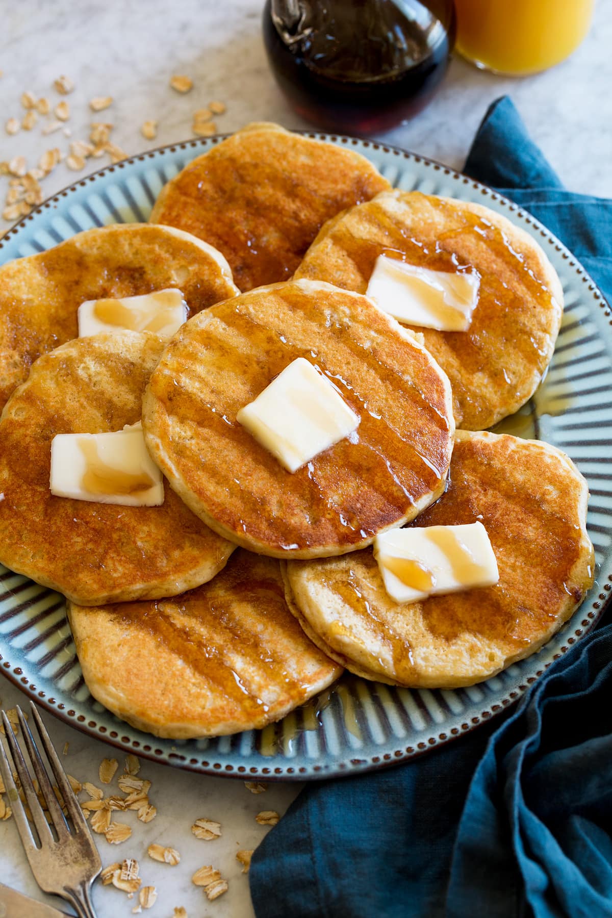 Oat Flour Pancakes Pancakes shown at a side angle on a large blue plate.