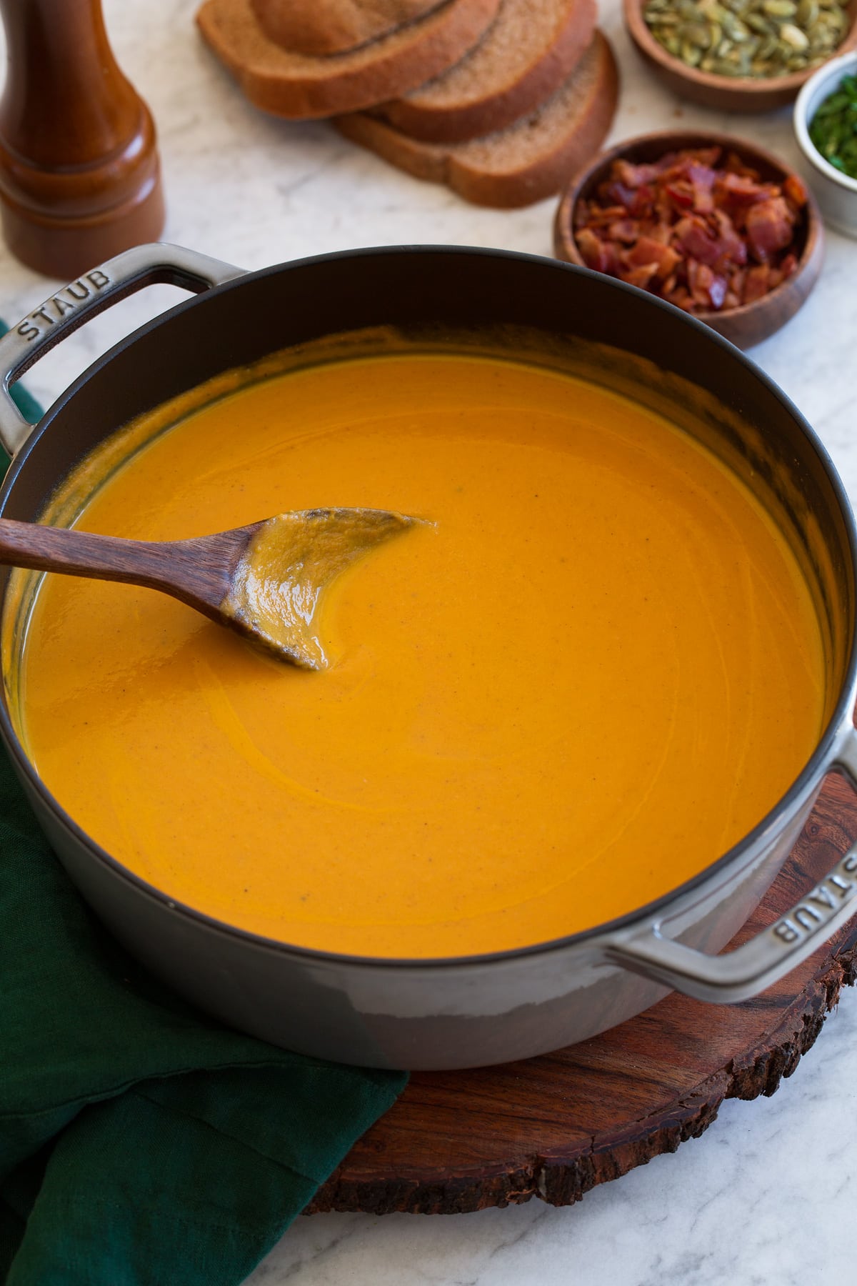Pumpkin Soup Pot of pumpkin soup with wooden ladle.