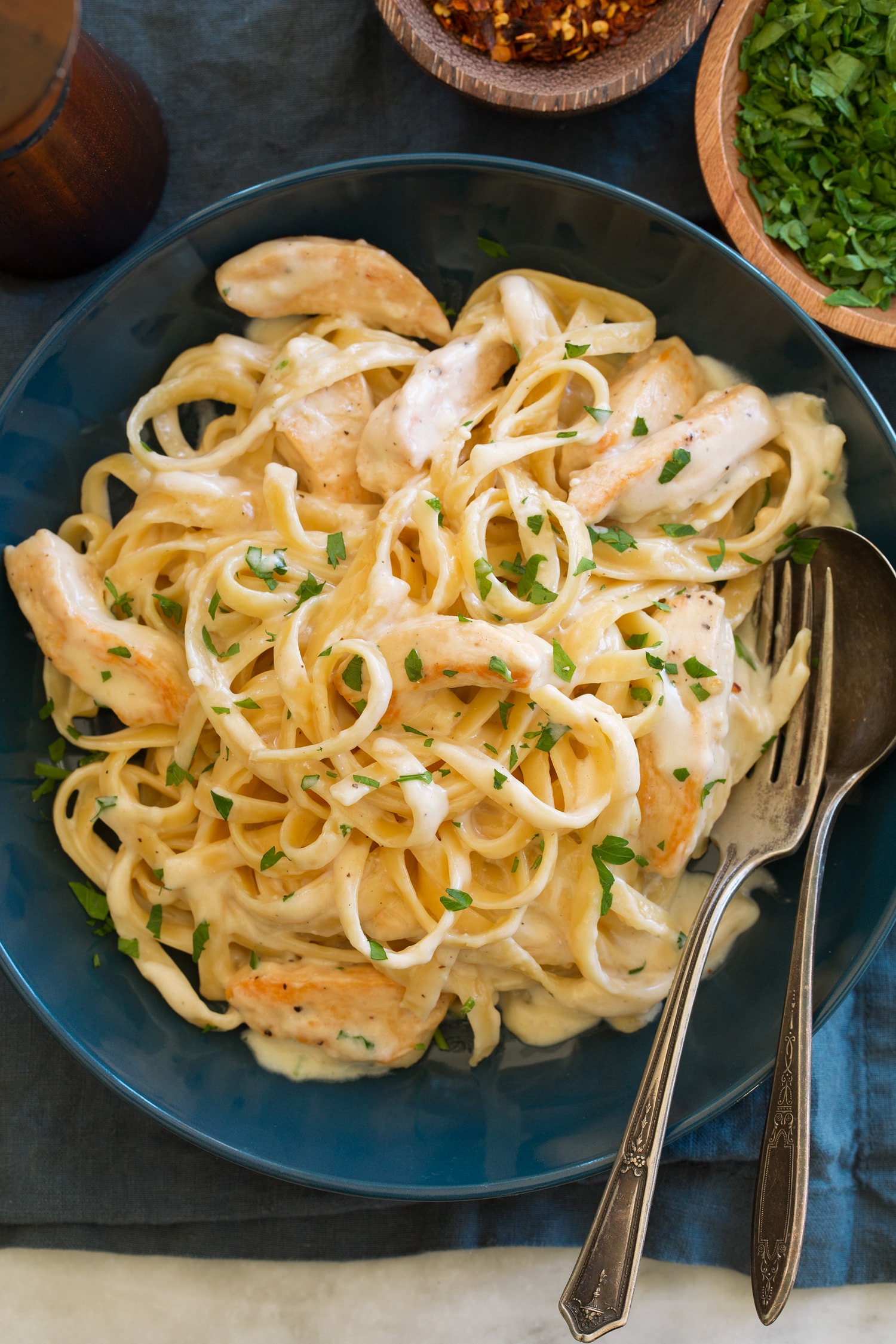 Chicken Alfredo Overhead photo of chicken alfredo in blue bowl.