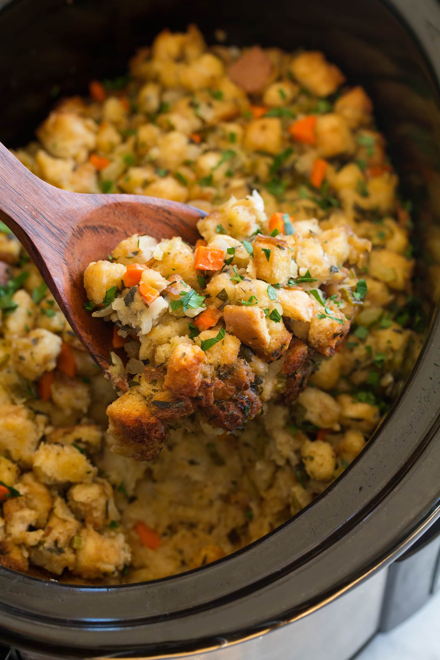 Scoop of stuffing lifted from slow cooker.