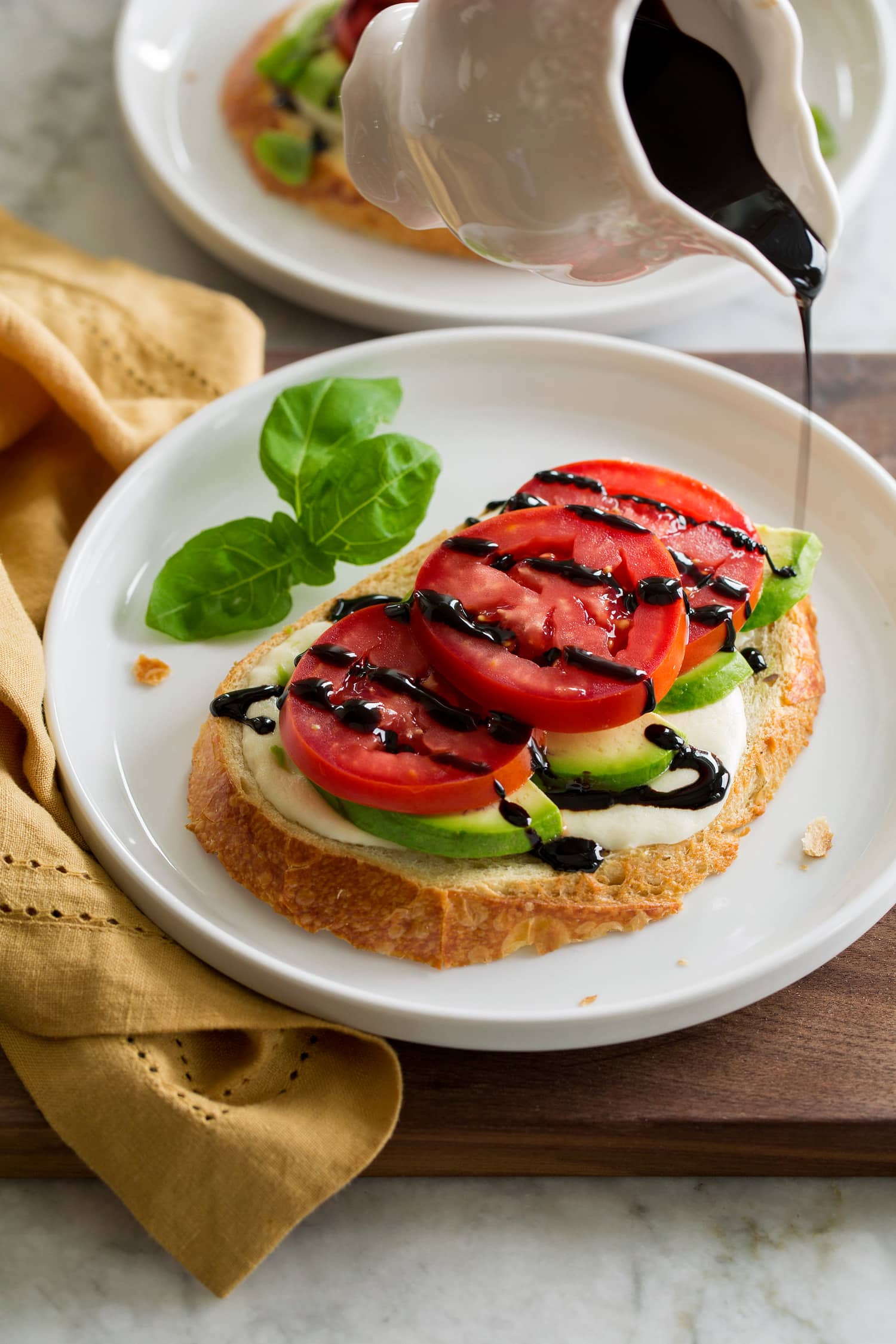 Balsamic Glaze Homemade balsamic glaze being drizzled over avocado caprese toast.