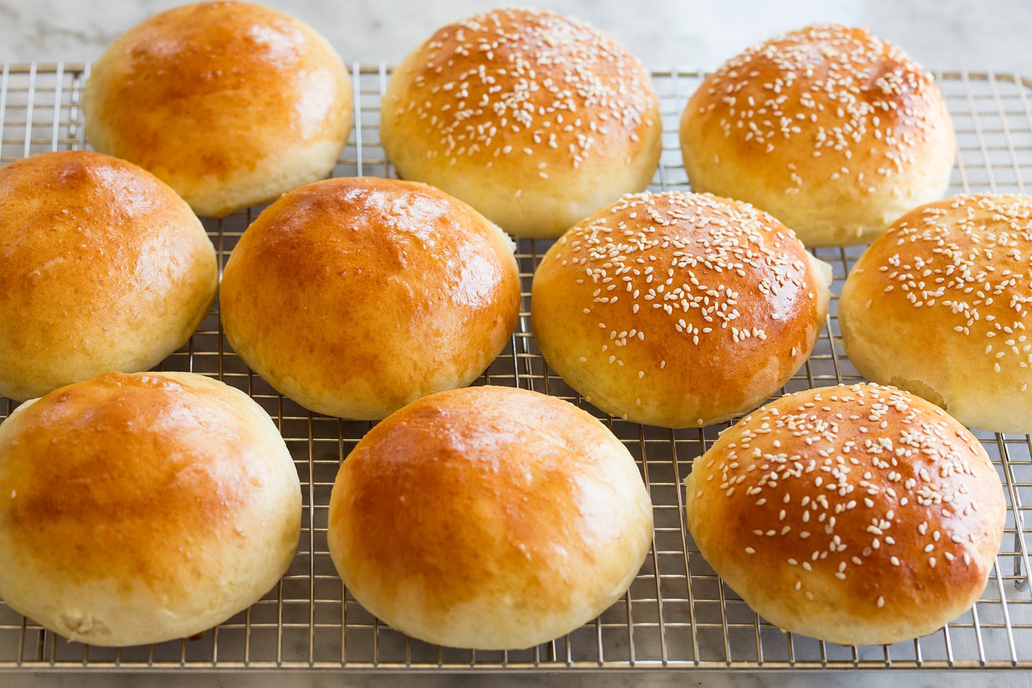 Finished golden brown buns on cooling rack.