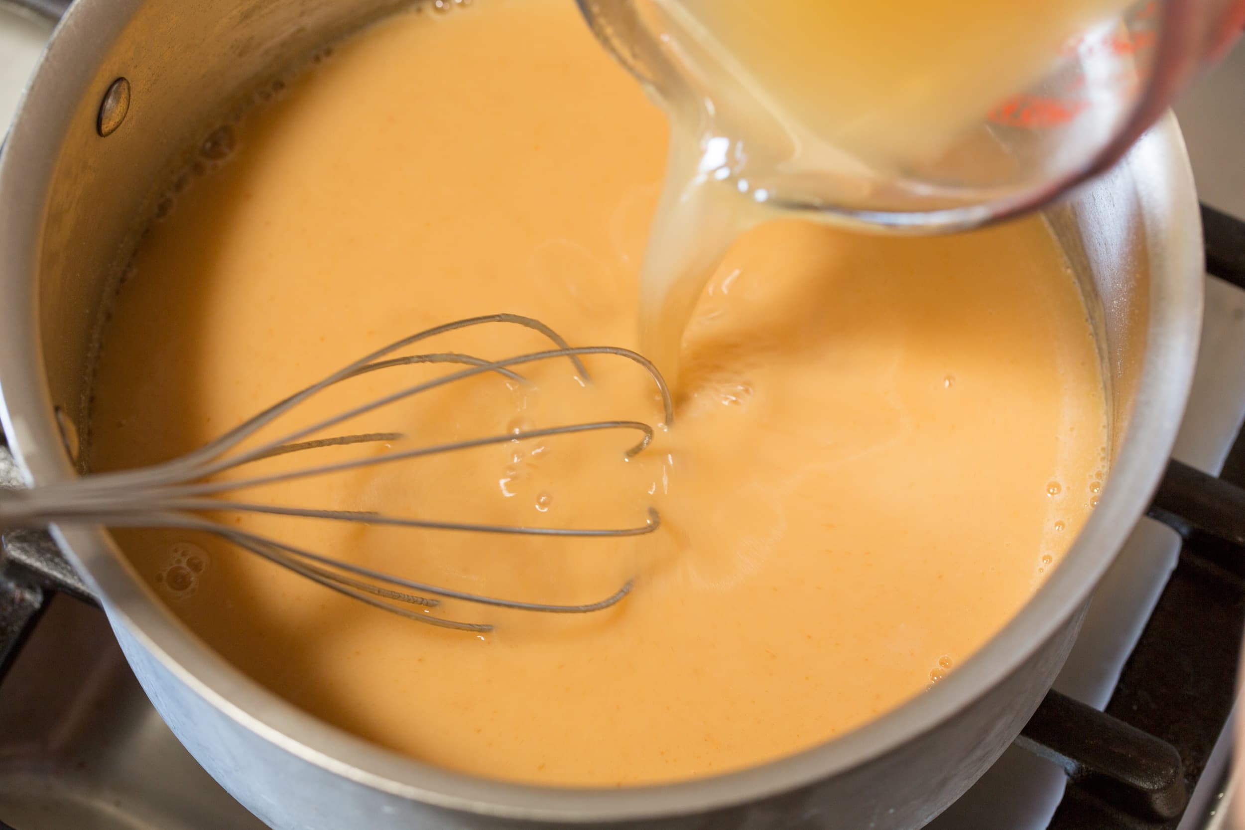 Chicken Gravy Broth added to roux in pan.