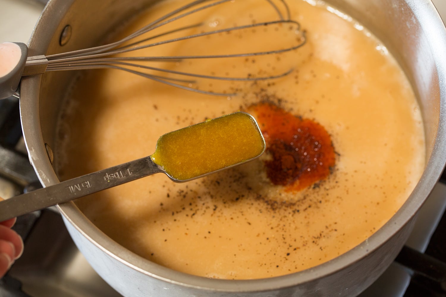 Chicken Gravy Adding chicken base and seasonings to gravy.