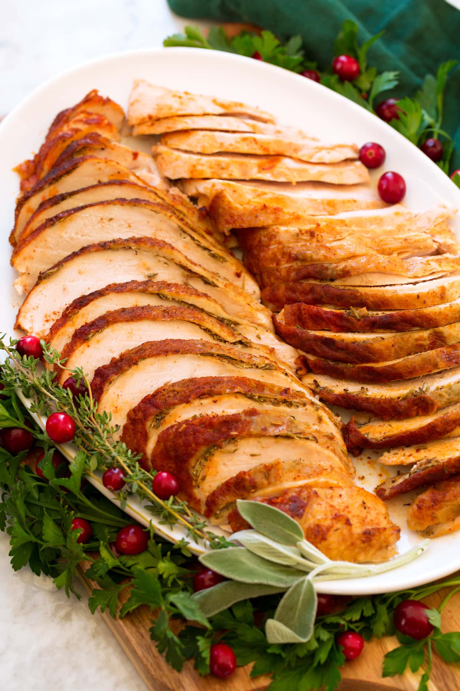 Crockpot Turkey Breast Side angle of cooked turkey breast on a platter.