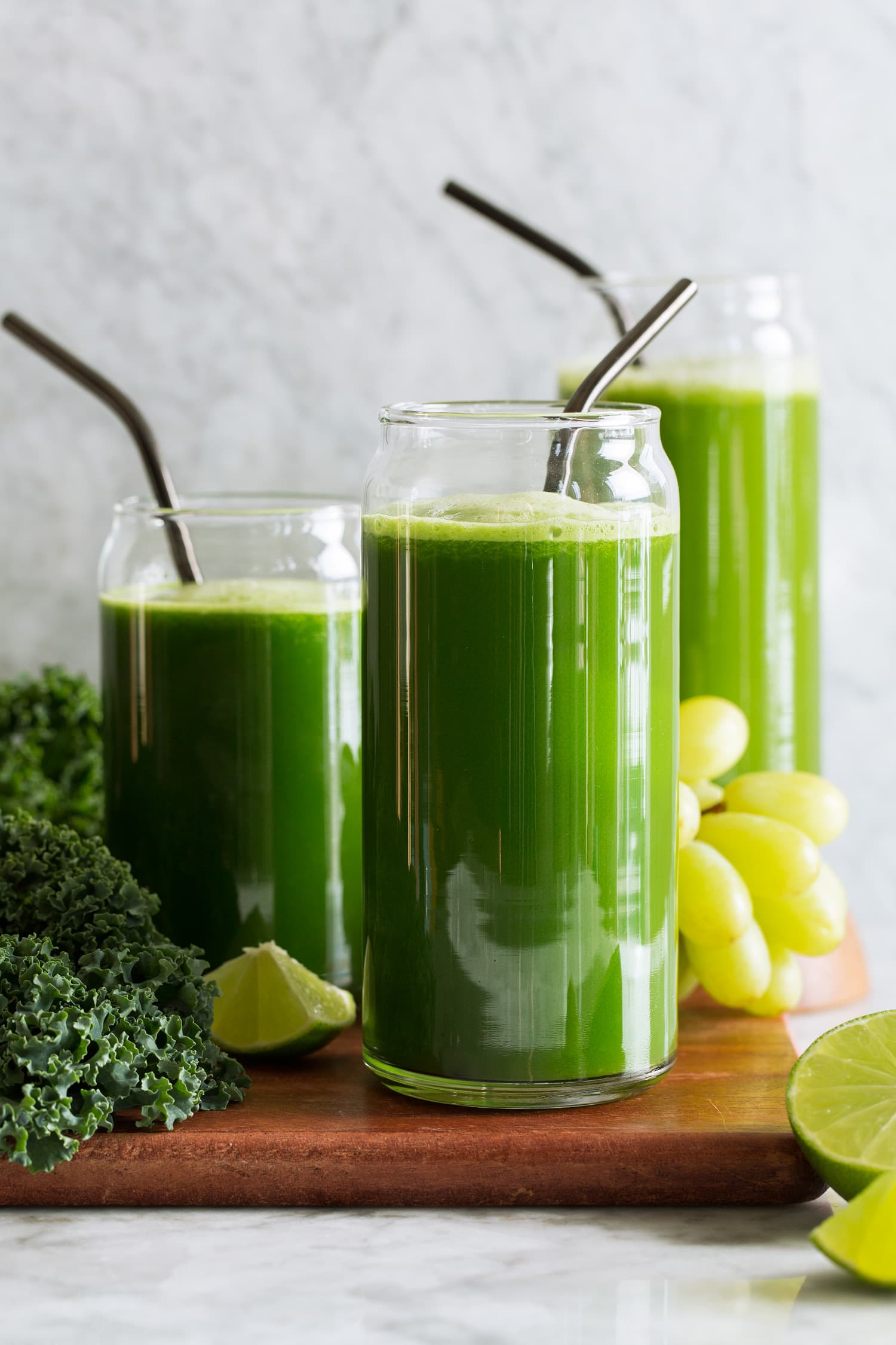Green Juice Three servings of green juices made with different greens including spinach, romaine lettuce and kale. Also includes cucumber, grapes, apples, celery, broccoli, lime and ginger.