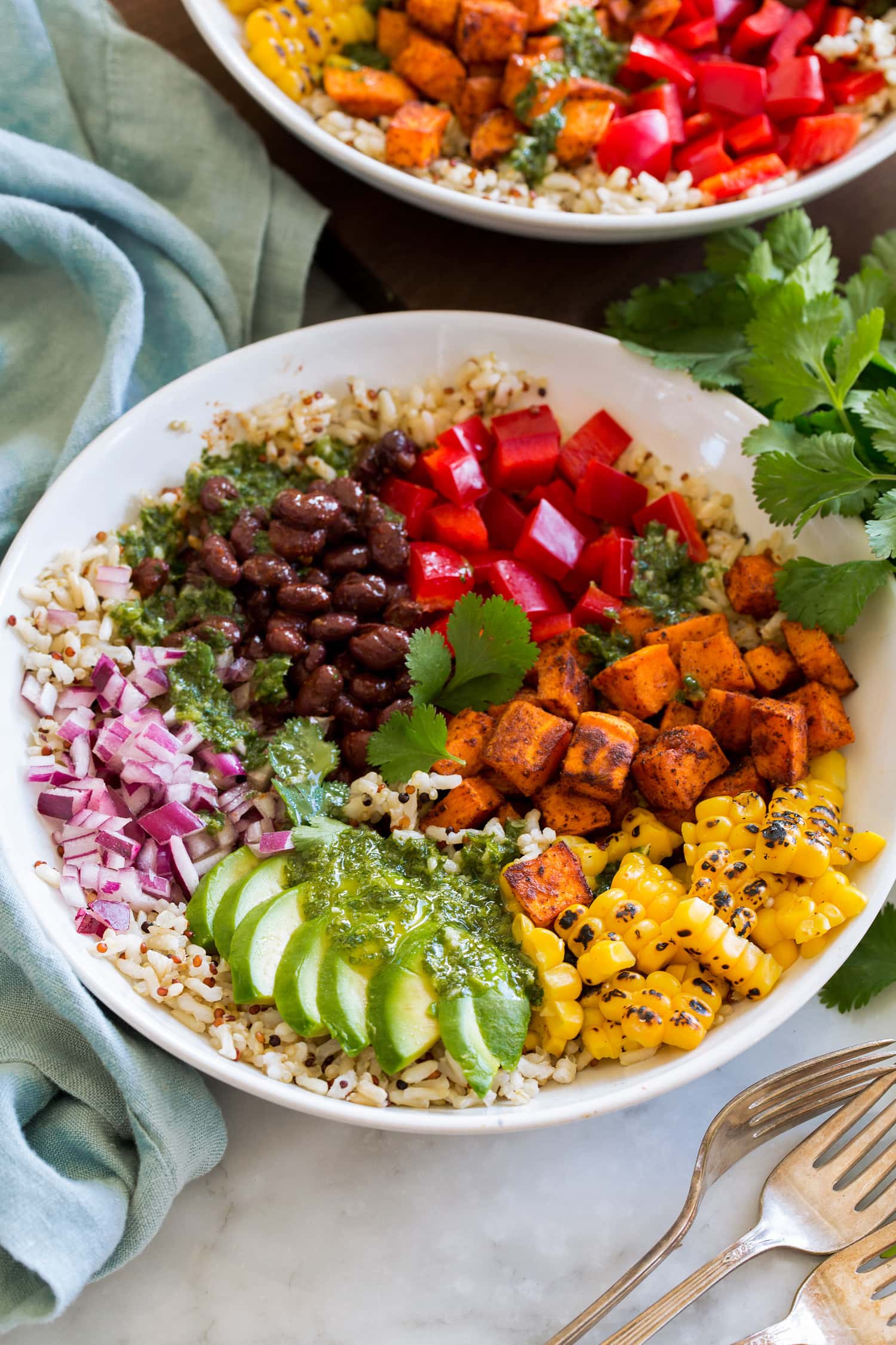 Baja Grain Bowl Baja grain bowl with black beans, tomatoes, sweet potatoes (or chicken), corn, avocado, red onion, brown rice and quinoa.