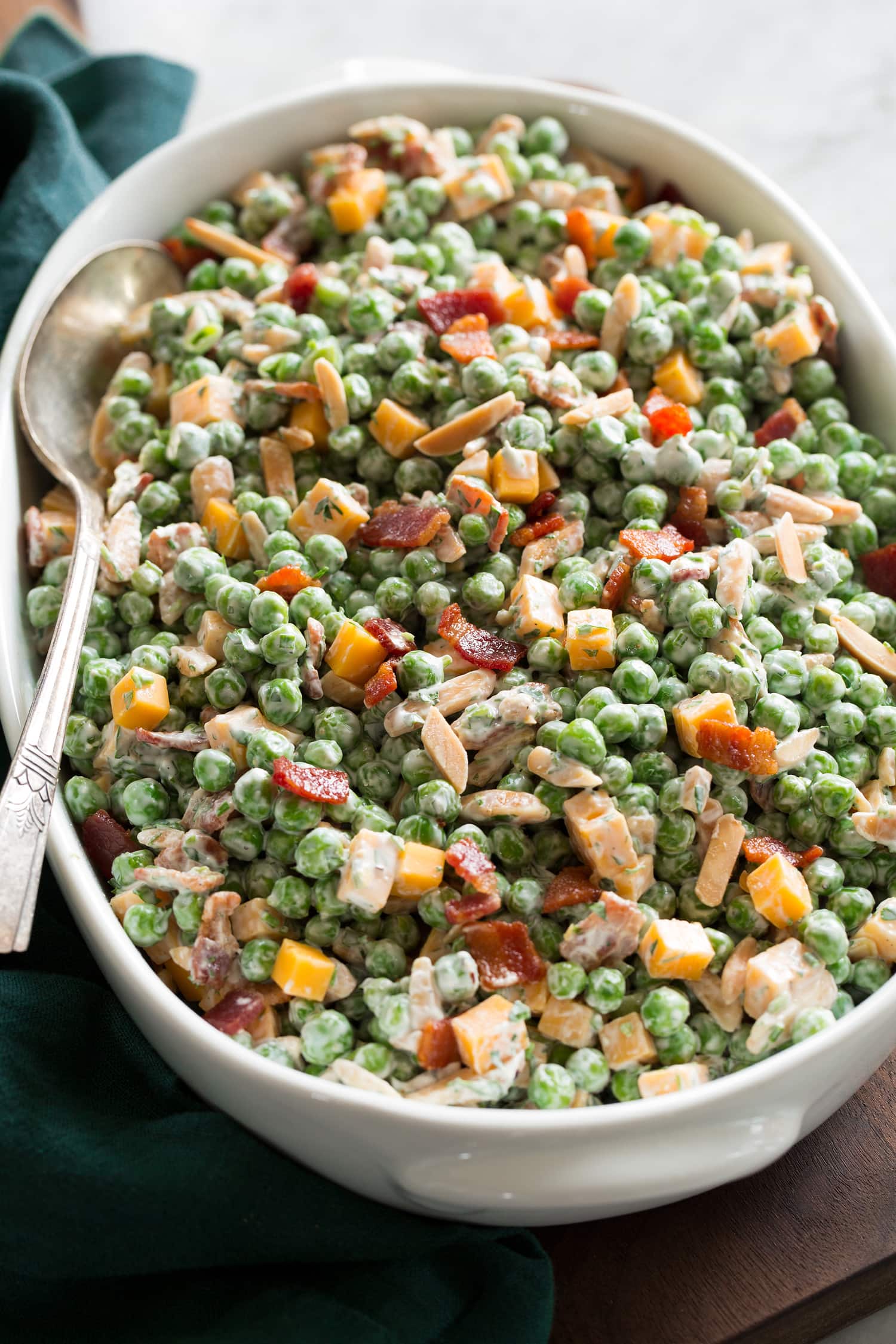 Pea Salad Side angle of pea salad in a white serving dish.