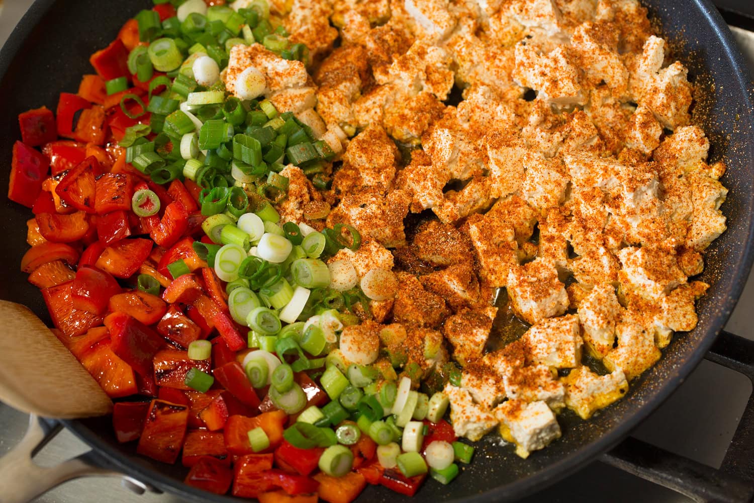Tofu Scramble Adding tofu, green onions and seasonings to skillet.