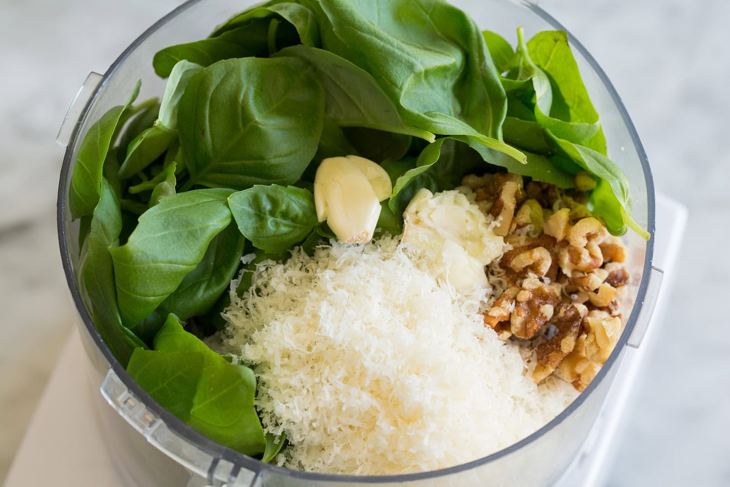 Pesto Pasta Salad Pesto ingredients in a food processor before mixing.