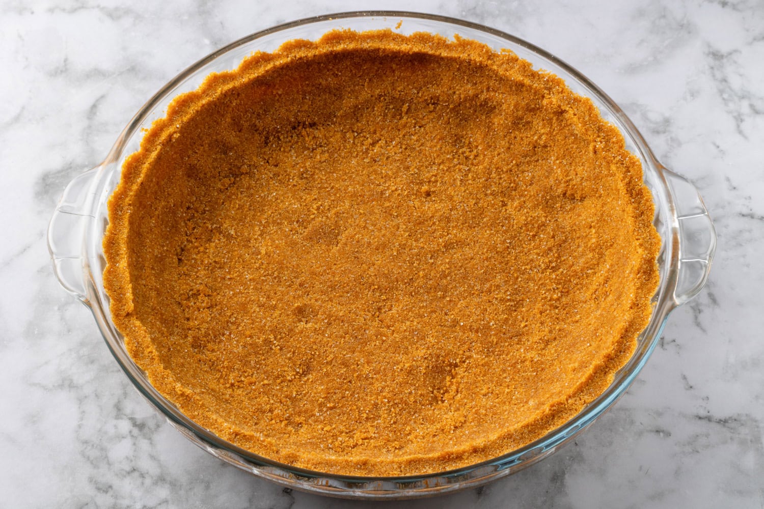 Lemon Icebox Pie Graham cracker crust mixture pressed into a pie dish.