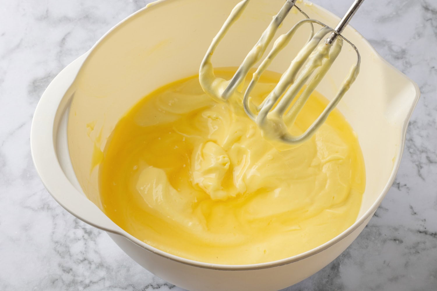 Lemon Icebox Pie Gelatin added to lemon pie mixture in mixing bowl.