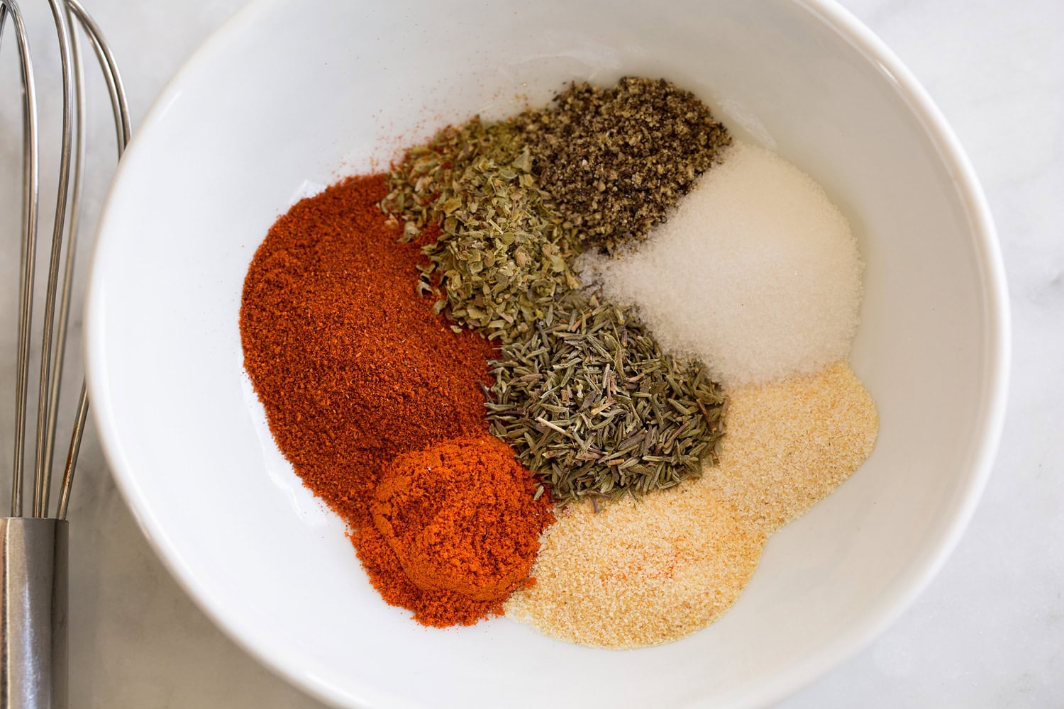 Blackened Shrimp Blackened shrimp seasoning in a white small bowl. Shown before mixing spices.