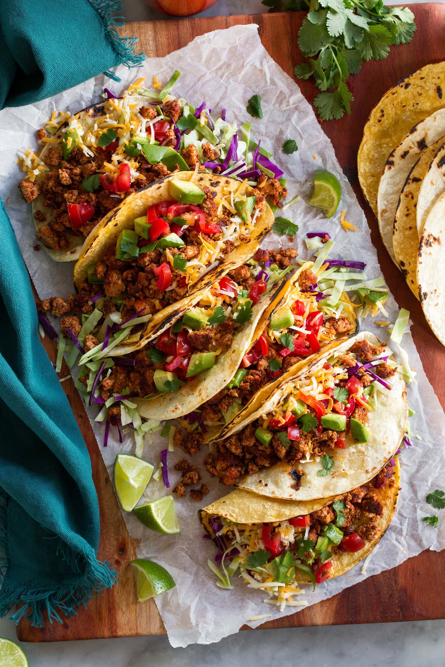Tofu Tacos Crumbled tofu meat tacos with toppings of cabbage, tomatoes, cilantro and cheese.