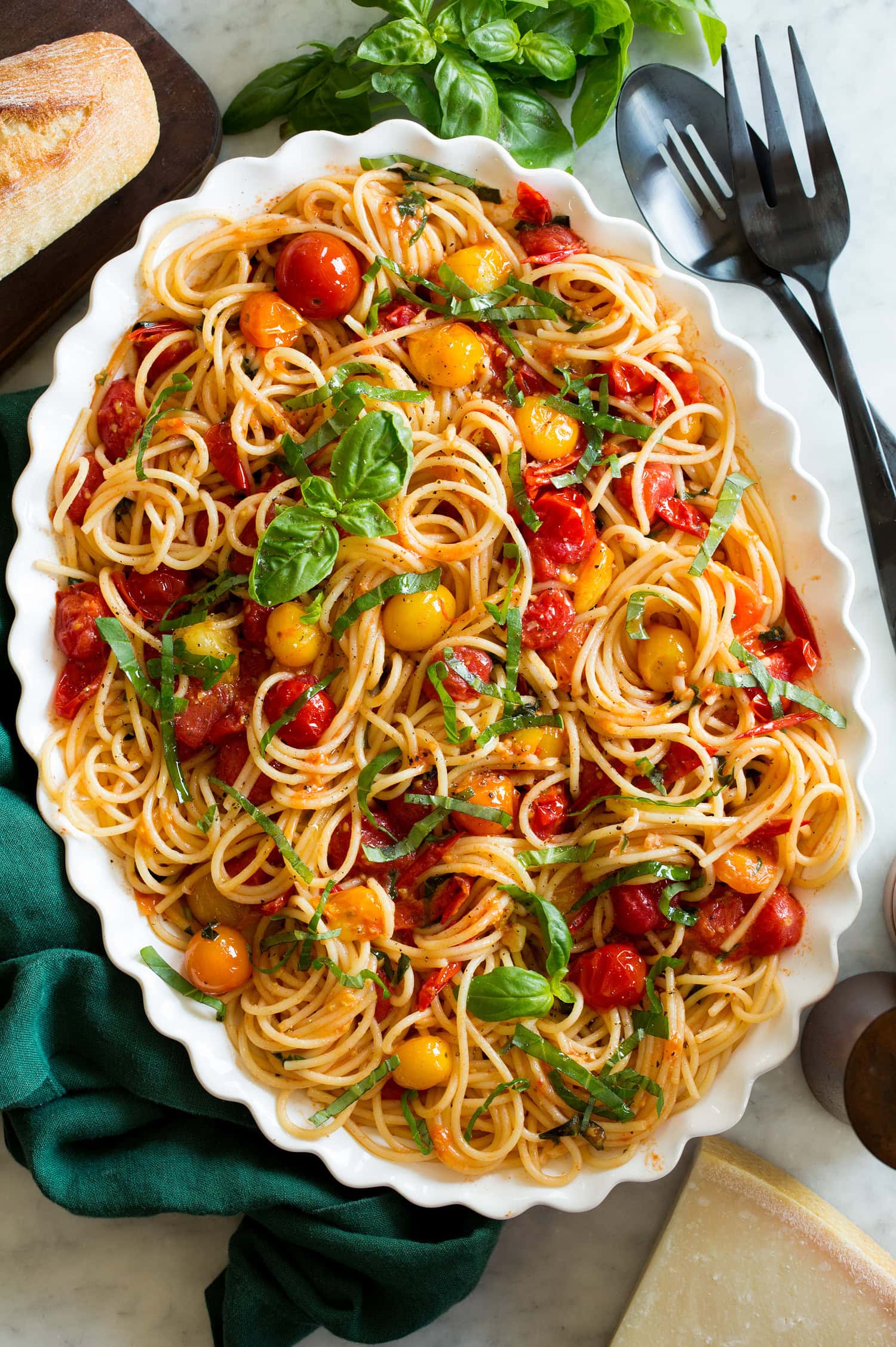 Cherry Tomato Pasta Cherry tomato pasta on a white oval scalloped serving platter.