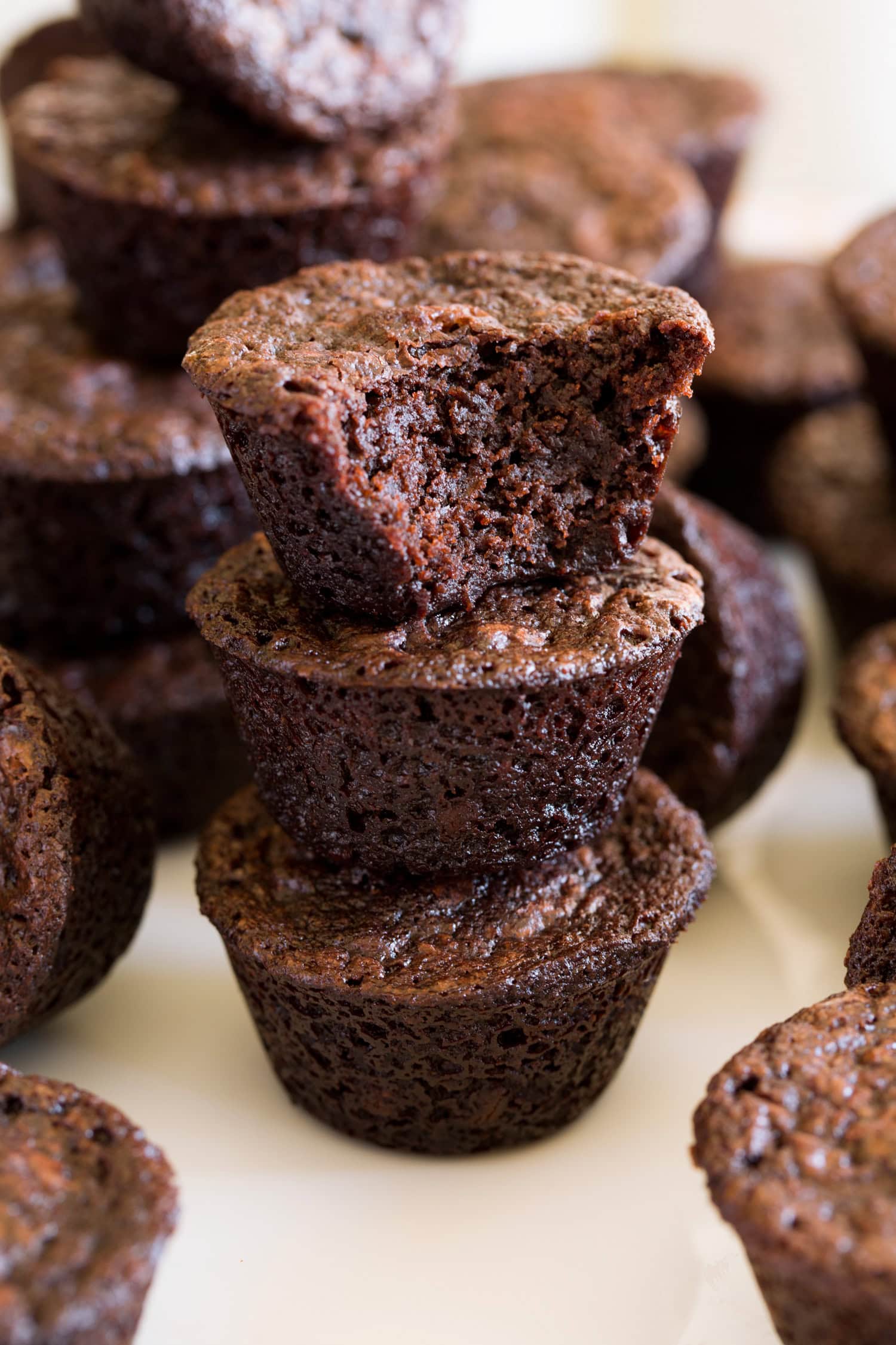 Brownie Bites Close up photo of brownie bites stacked with one bitten into showing texture.
