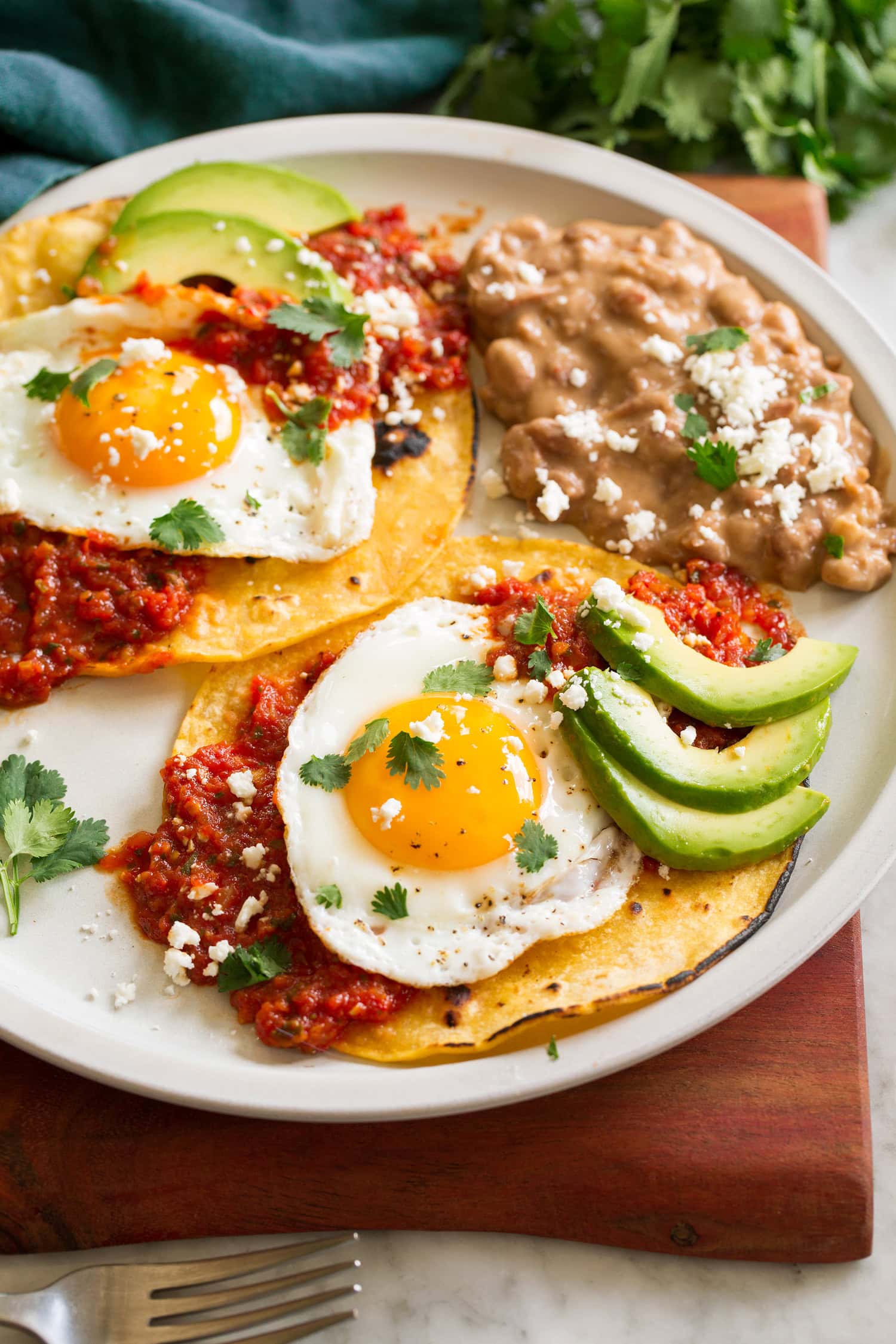 Huevos Rancheros Huevos rancheros served tortillas, salsa ranchero, fried eggs, avocado, and cotija.