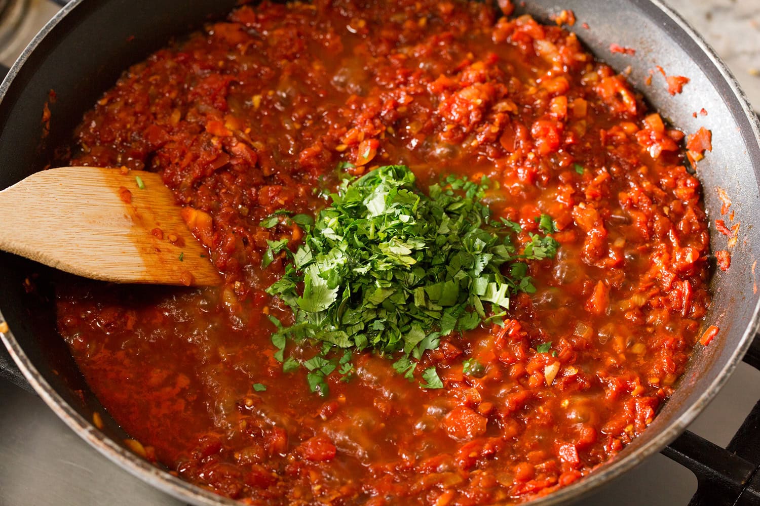 Huevos Rancheros Cilantro added to salsa ranchera mixture.