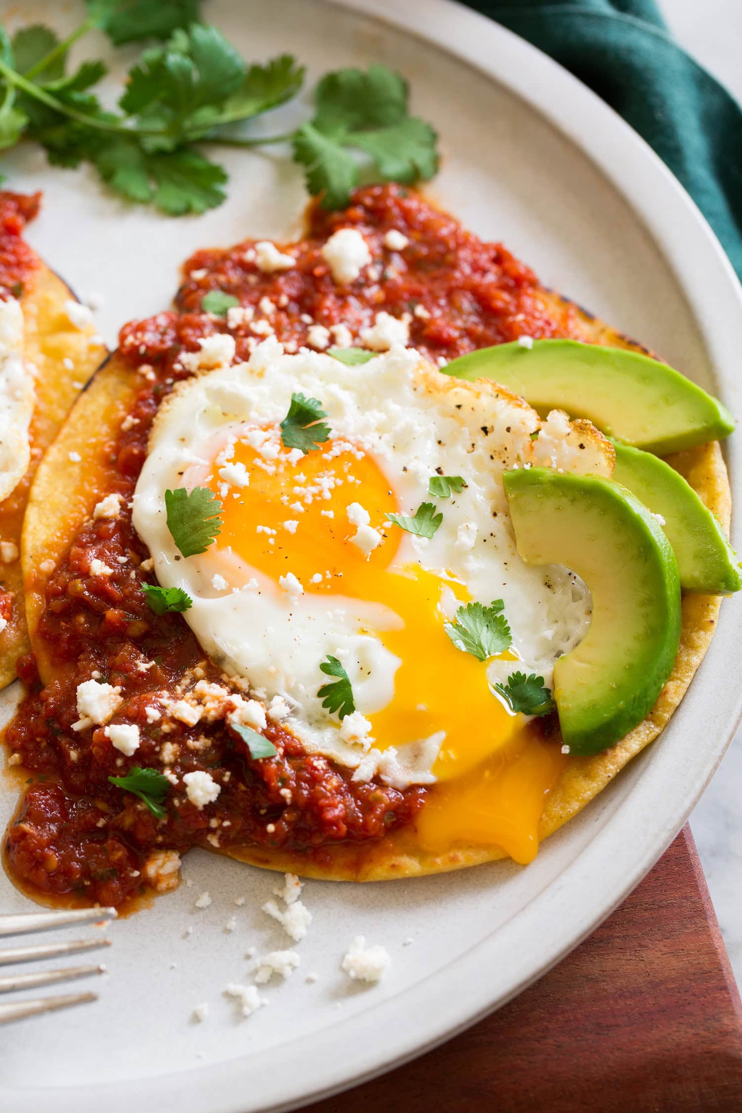 Huevos Rancheros Close up photo of huevos rancheros with egg yolk running down side.