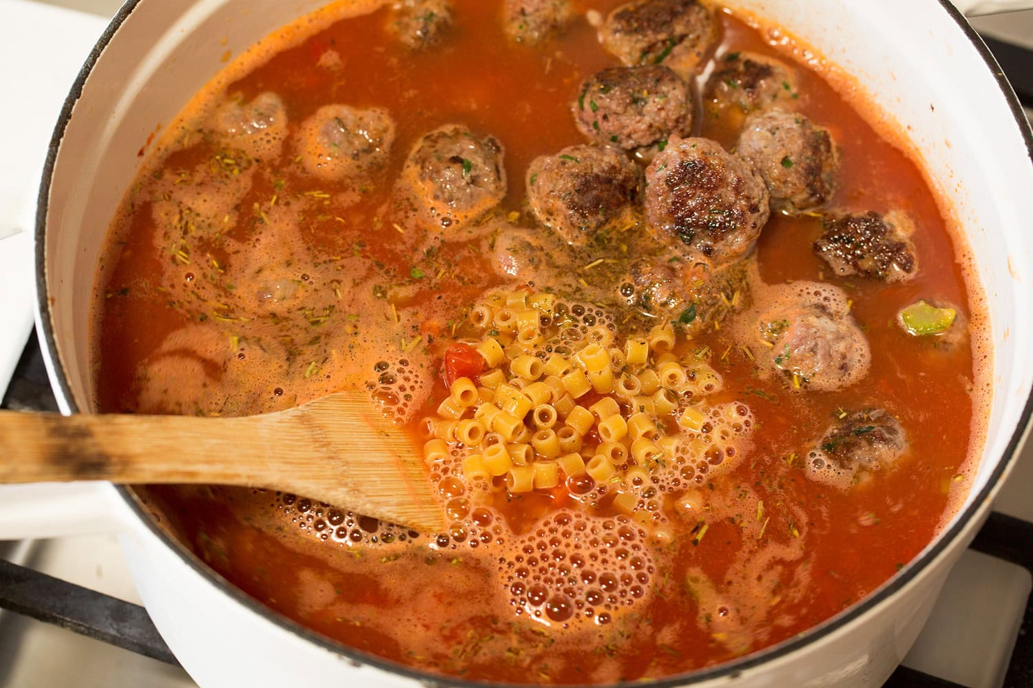 Meatball Soup Tomatoes, broth, seasoning, meatballs and pasta added to soup.