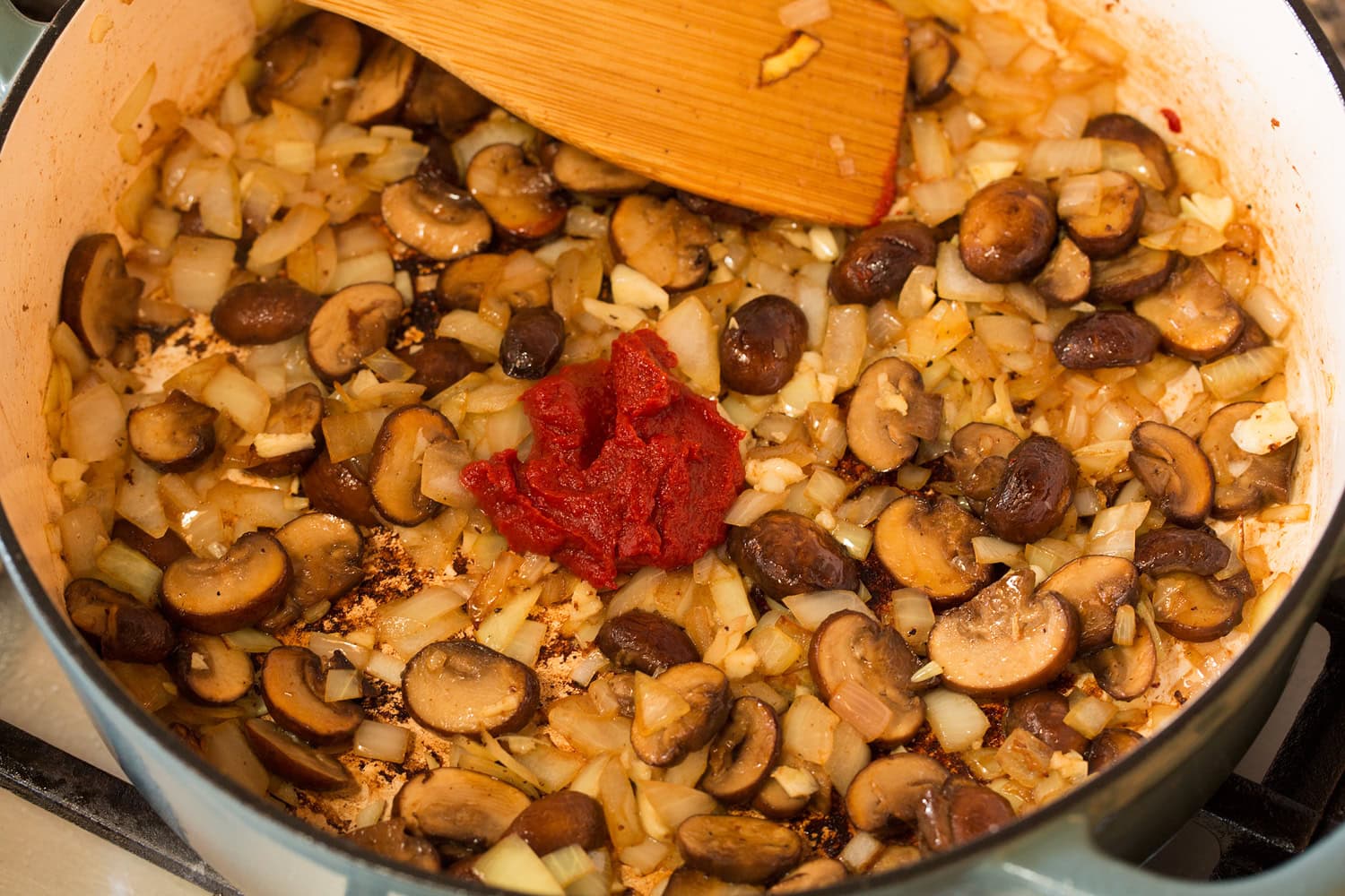 Coq au Vin Mushrooms, onions, garlic and tomato paste browned in a pot.