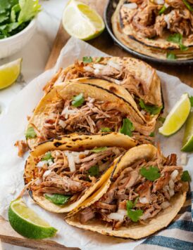 Pork carnitas shown in tortillas as tacos.