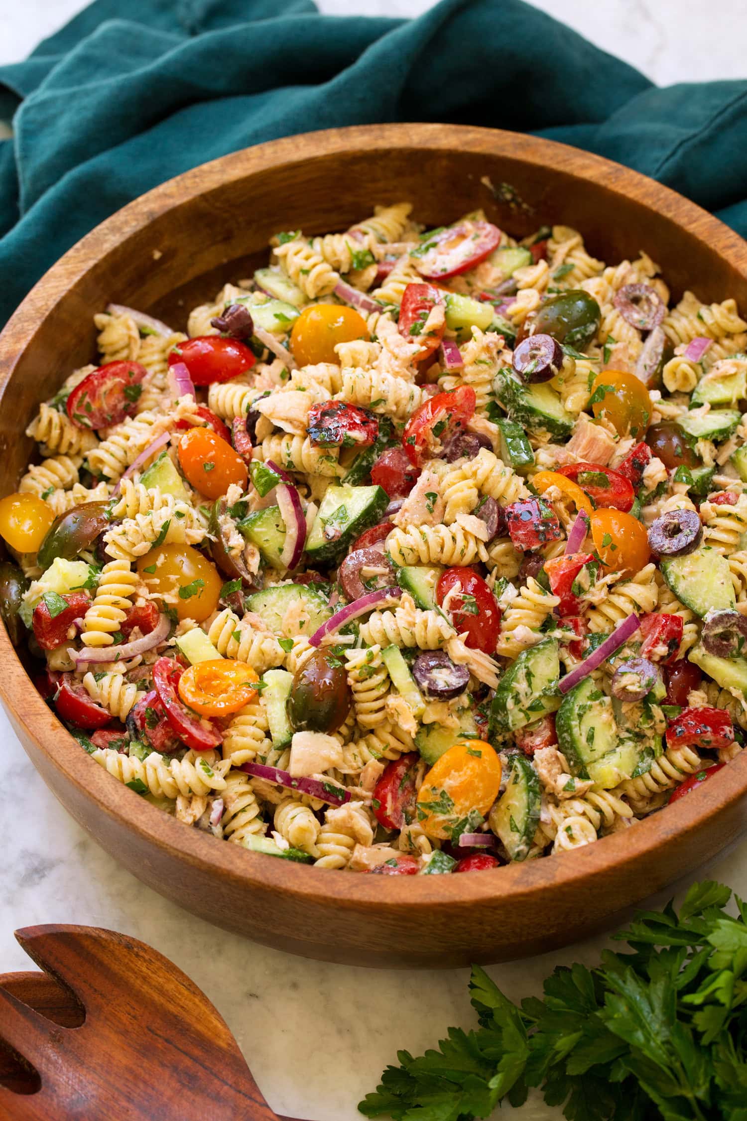 Tuna pasta salad in a wooden bowl.
