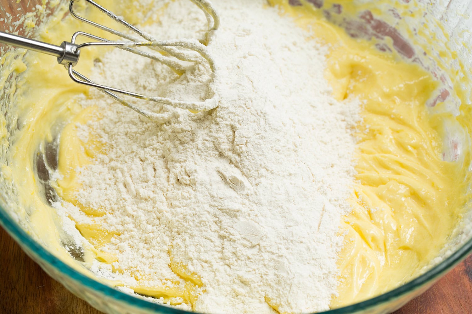 Lemon Pound Cake Flour mixture added to butter sugar mixture and electric whisk shown in picture.