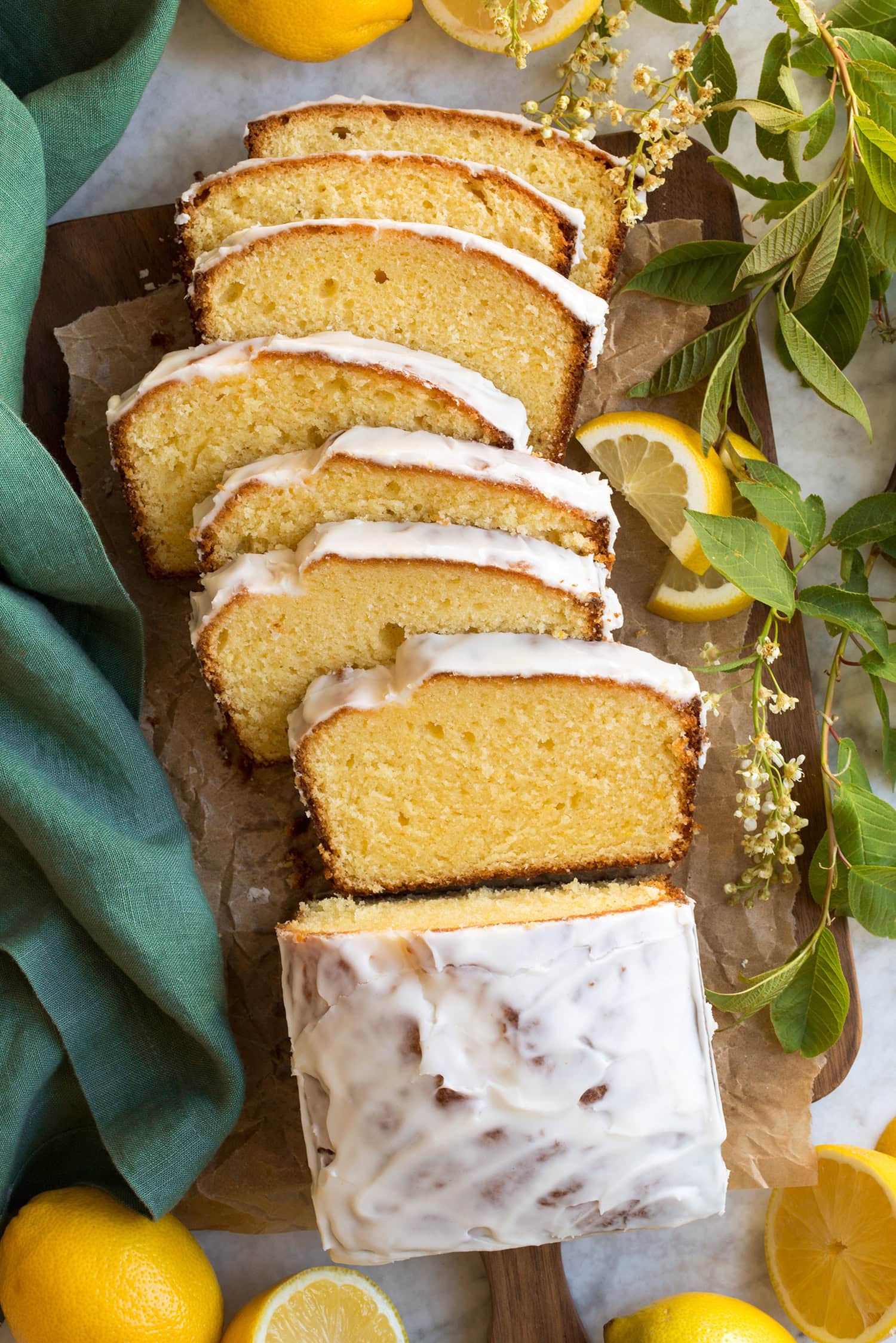 Lemon Pound Cake Overhead photo of lemon loaf sliced on a wooden cutting board.